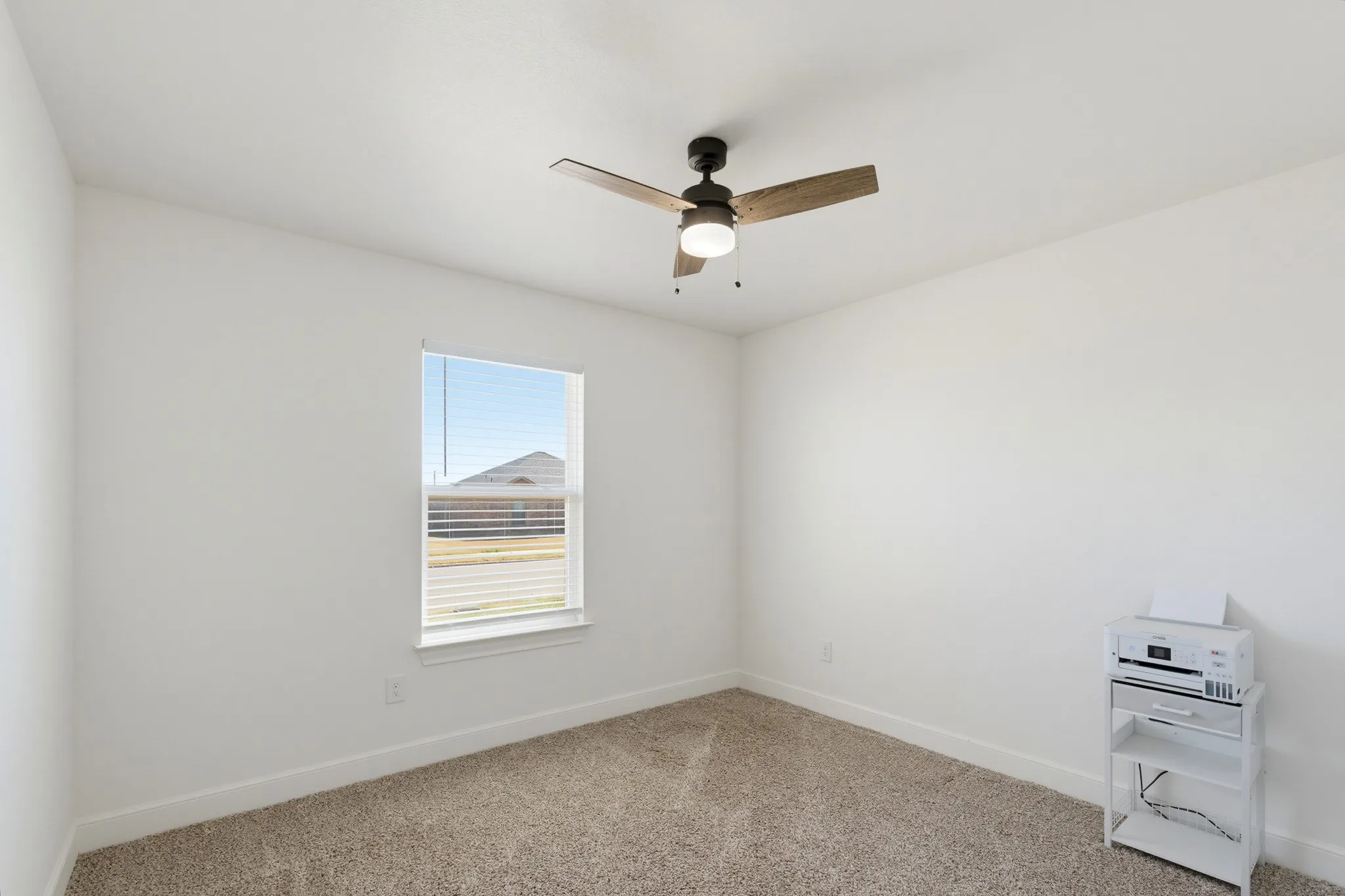 Neutral paint palette, carpet flooring, and a ceiling fan with light fixture