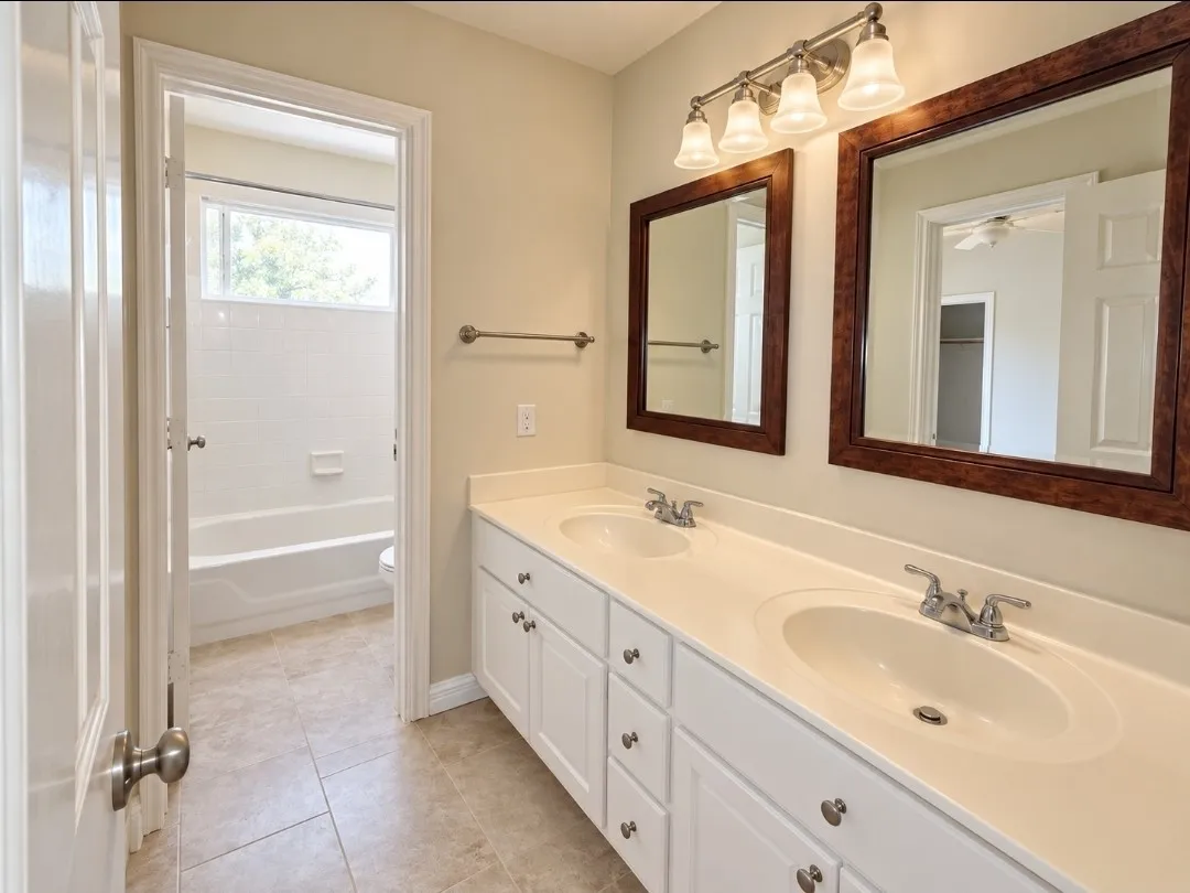Dual vanity with white cabinetry and integrated sinks