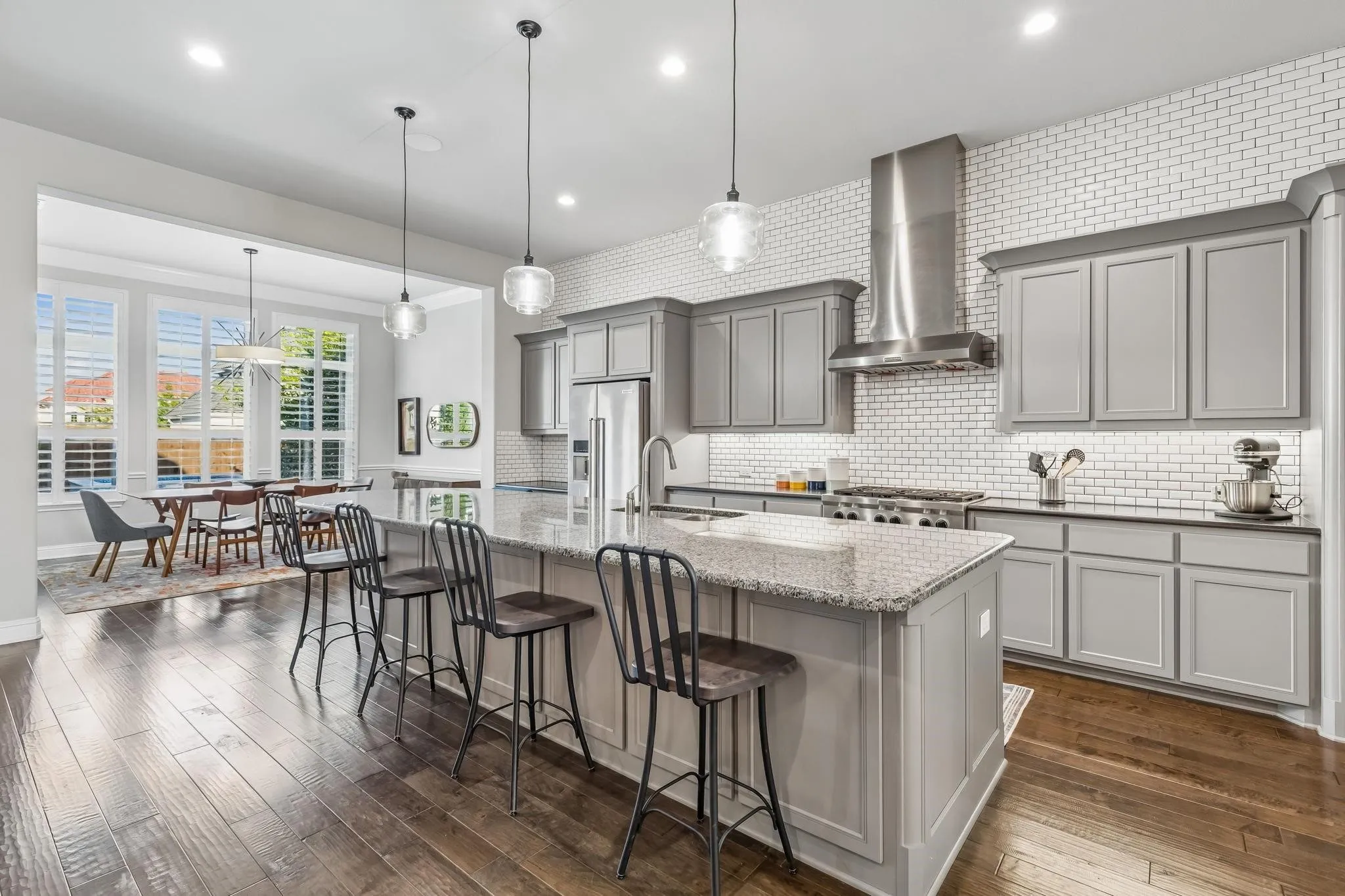 Spacious open kitchen featuring abundant cabinetry, including additional storage beneath the breakfast bar.