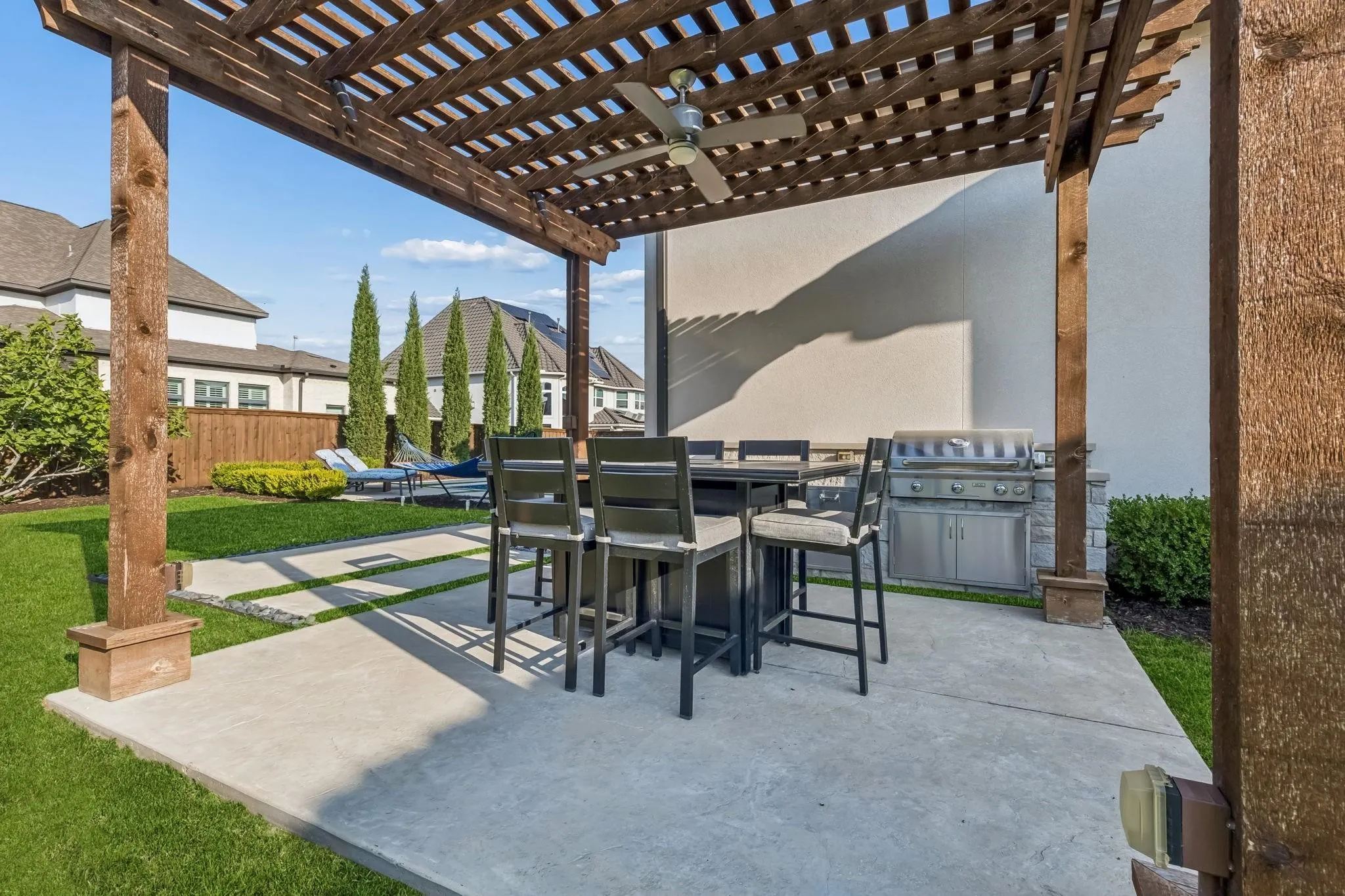 Separate pergola with a fully equipped outdoor kitchen creates the perfect space for entertaining family and friends.