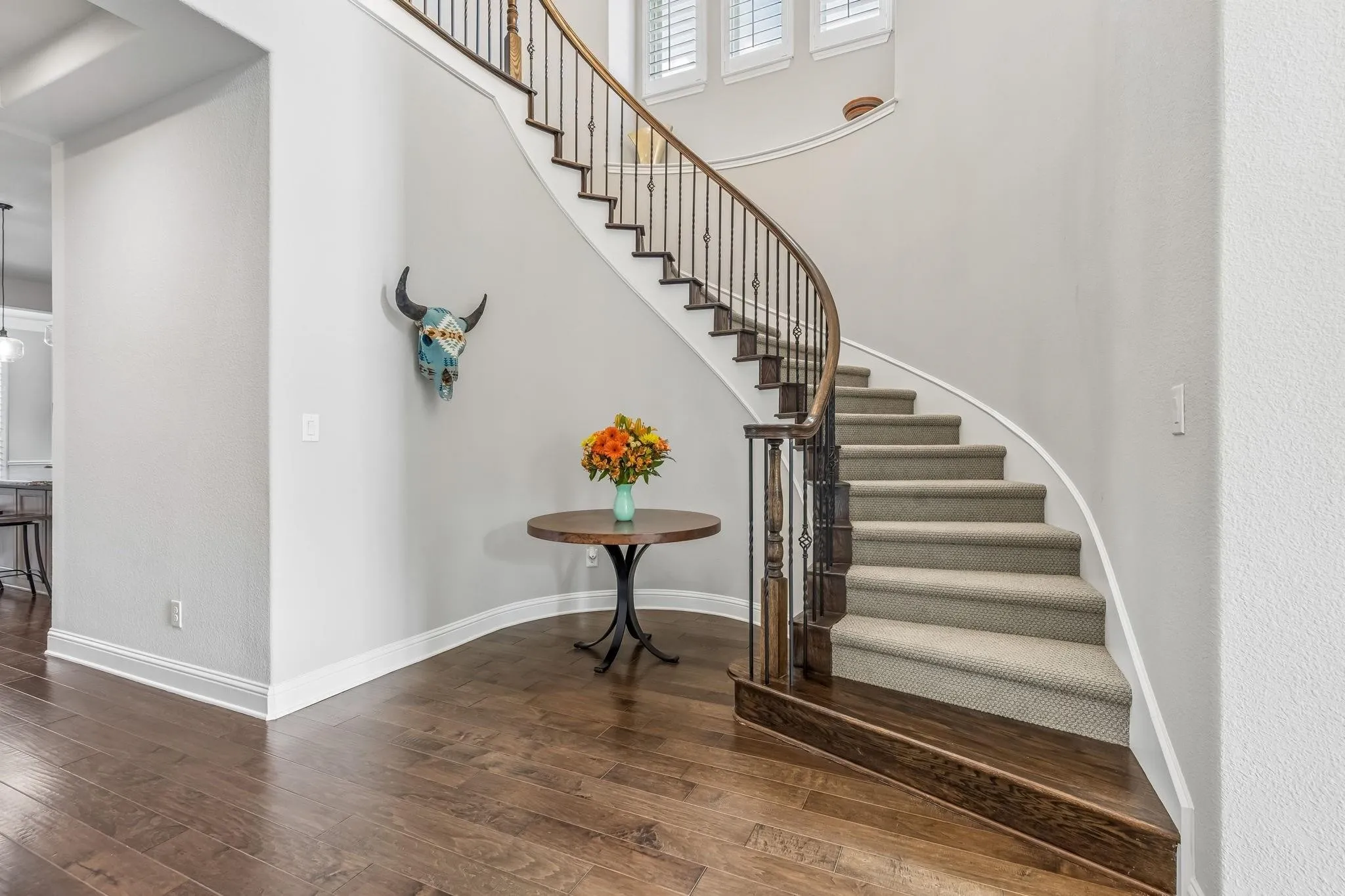 Elegant winding staircase creates a stunning focal point and grand first impression.