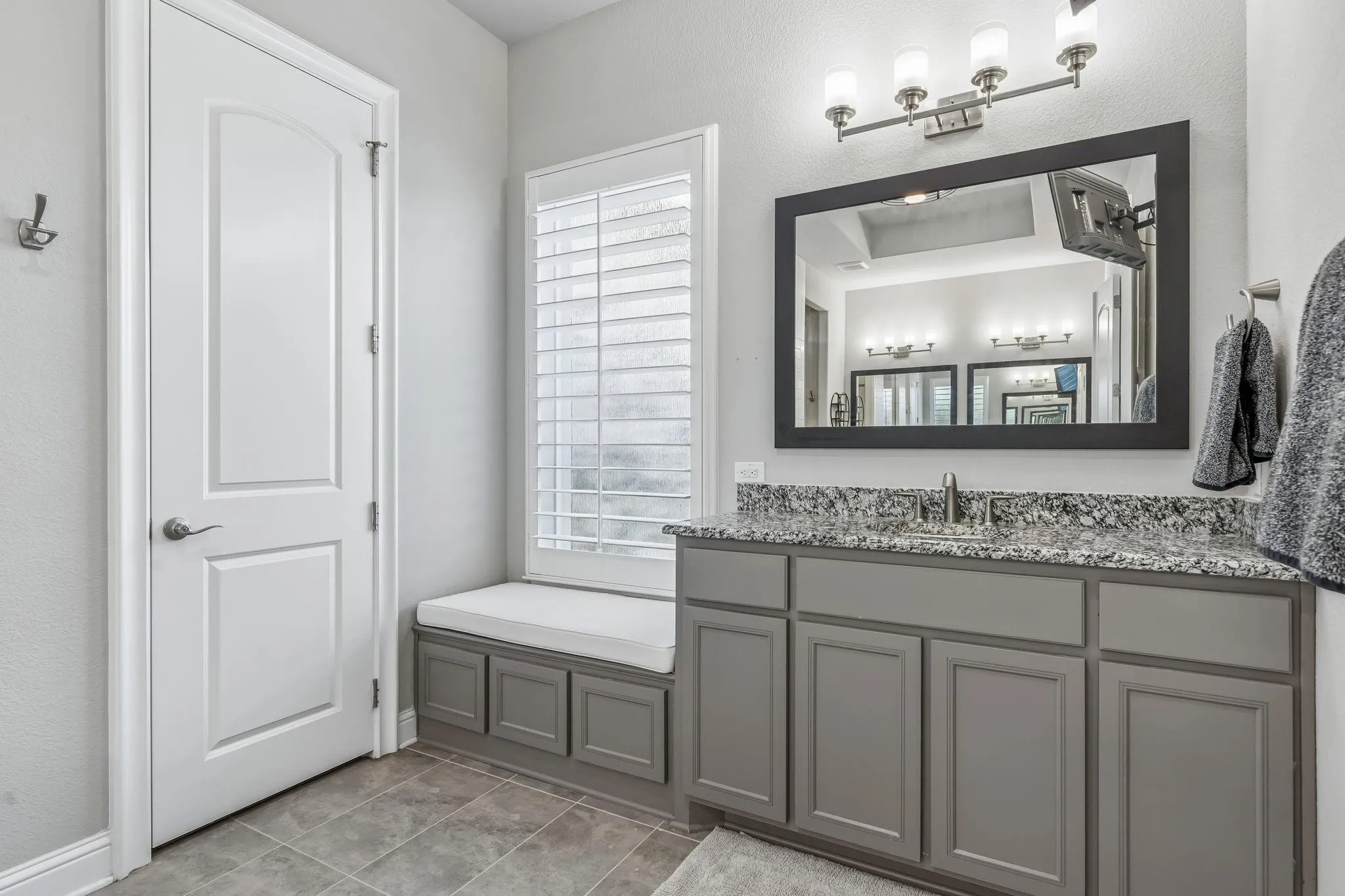 Spacious vanity with a built-in bench offers both comfort and convenience.