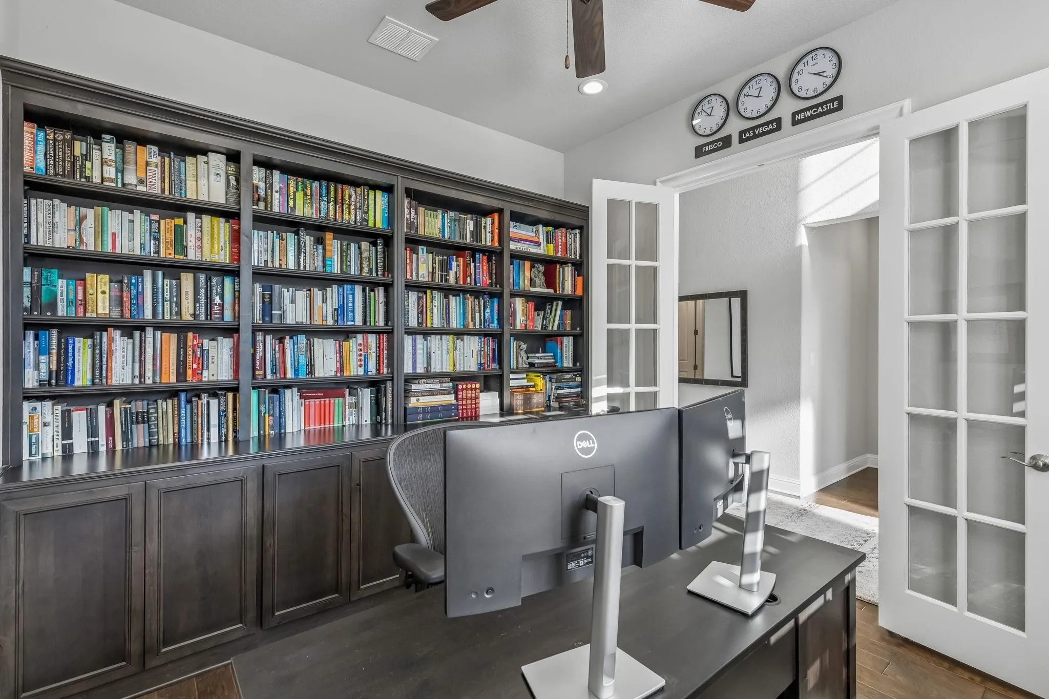 Private study with French doors and custom built-in bookshelves creates the perfect work-from-home space.