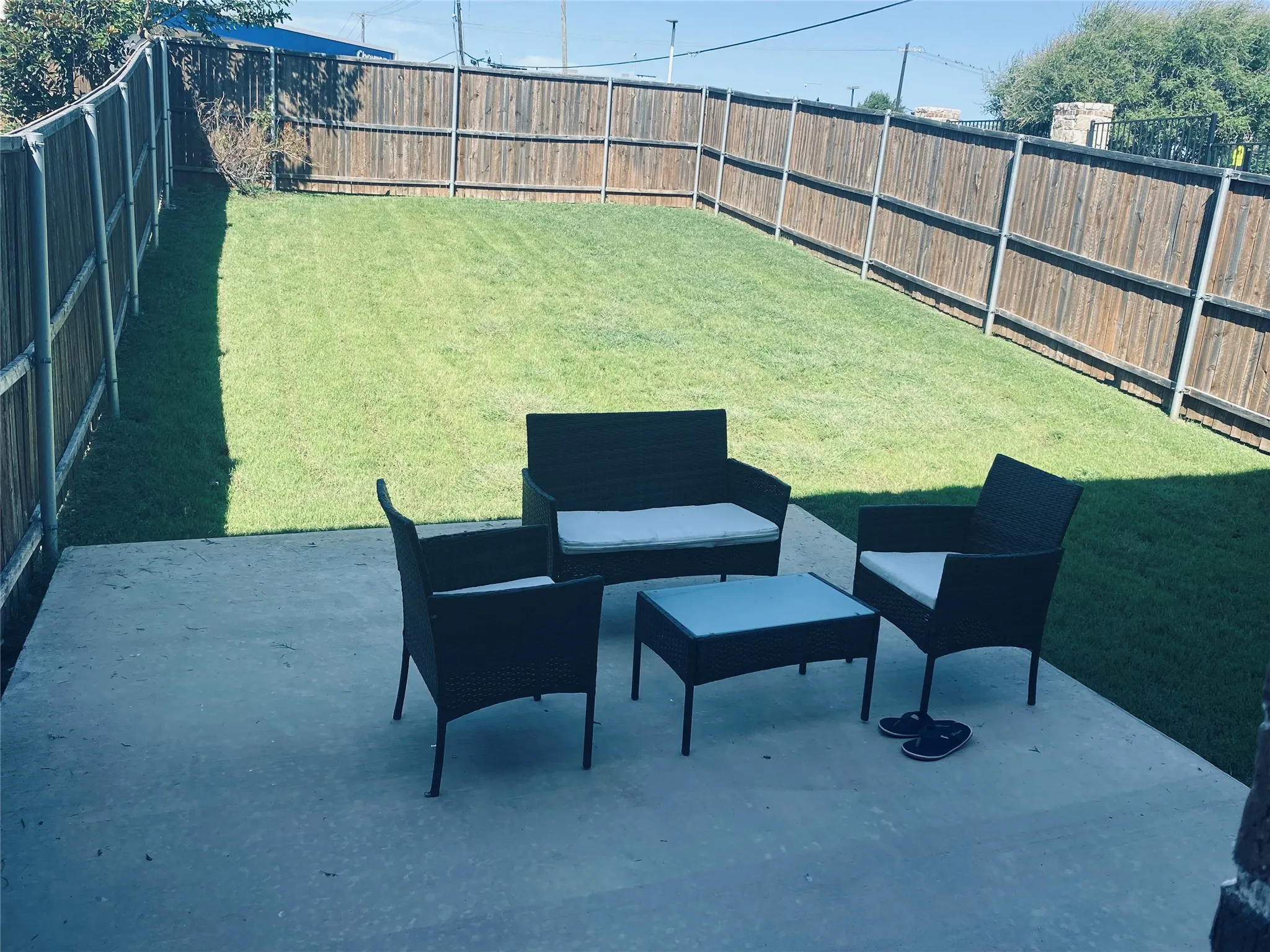 Fenced backyard with a patio area and outdoor lounge area