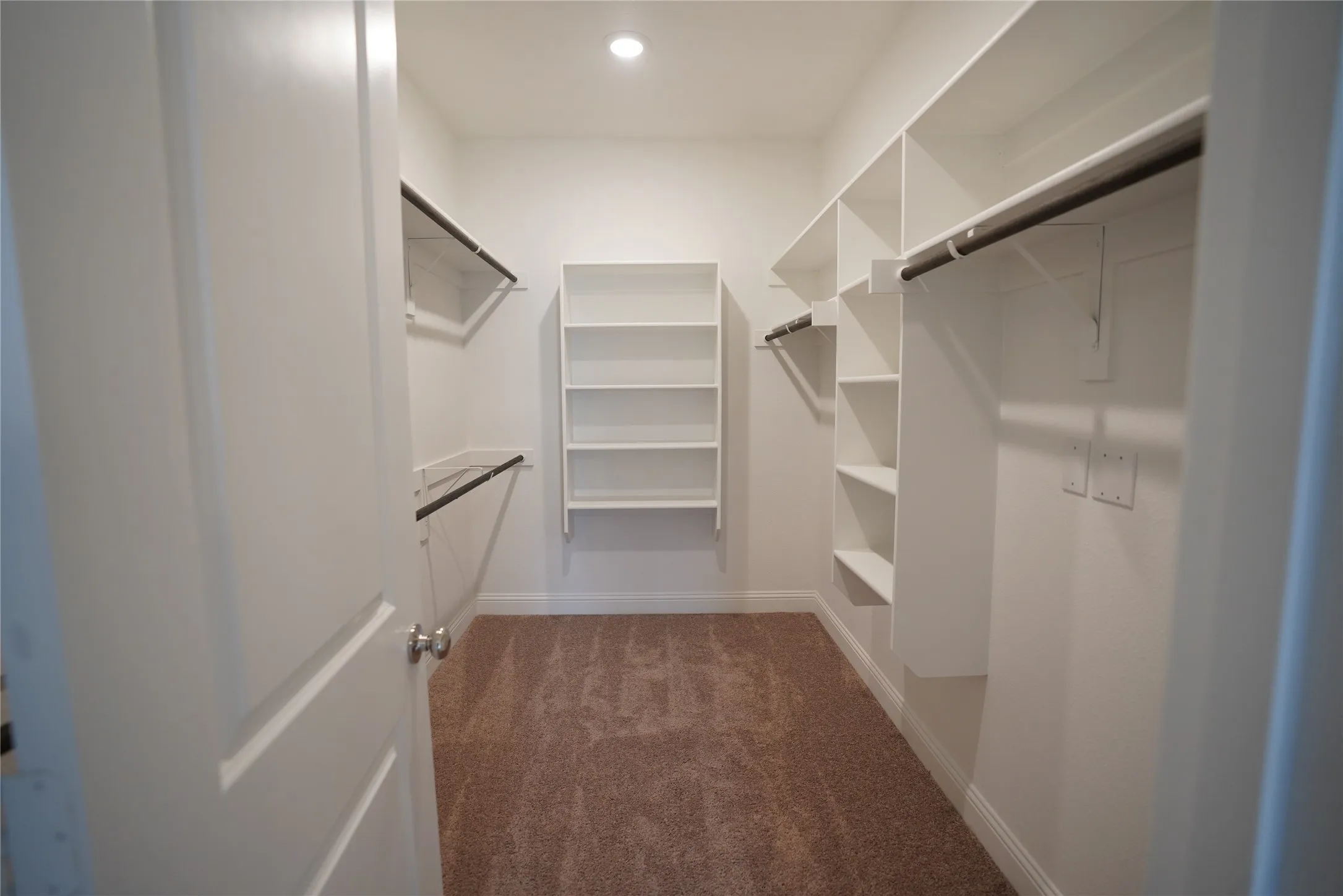 Spacious closet with carpet floors