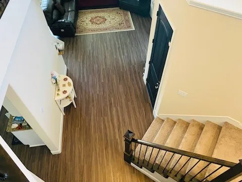 Stairs featuring wood finished floors