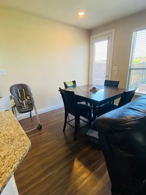 Dining area featuring dark wood-style floors and recessed lighting