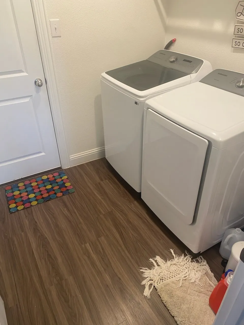Washroom featuring washer and clothes dryer and dark wood-style floors