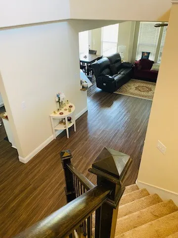 Stairs with wood finished floors and baseboards