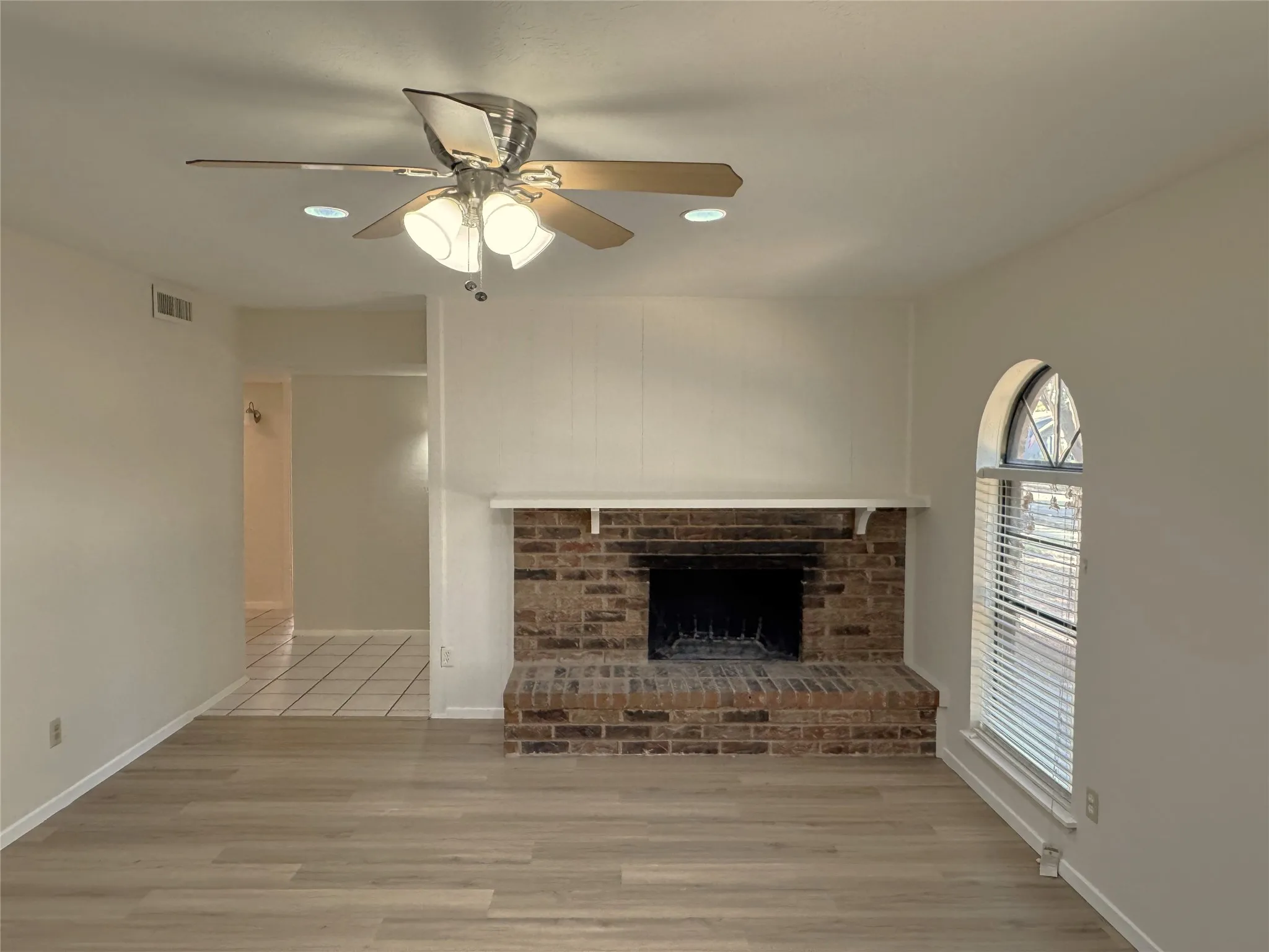 Living room with brick, wood burning fireplace