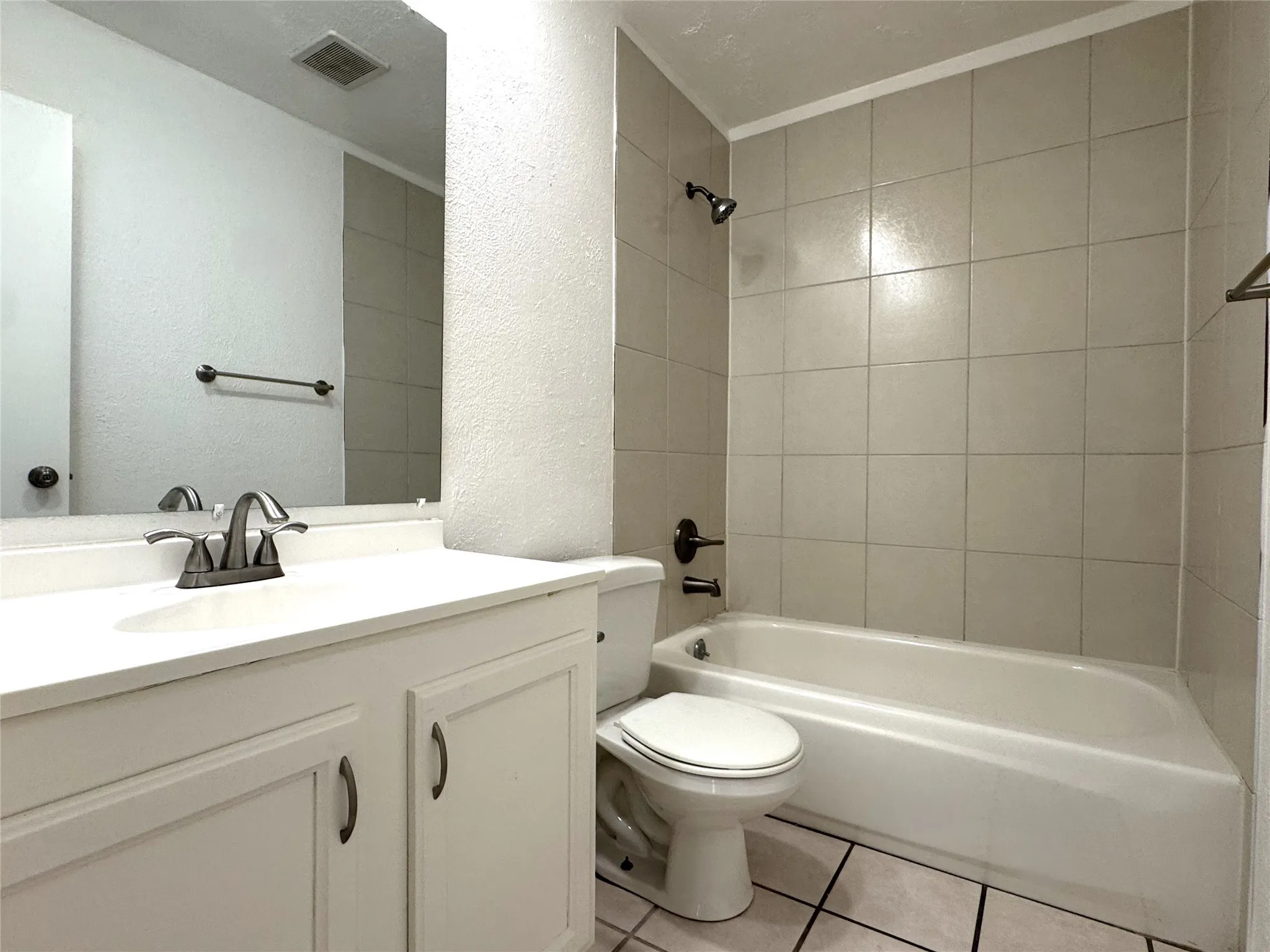 Shared full bathroom with natural stone counter tops