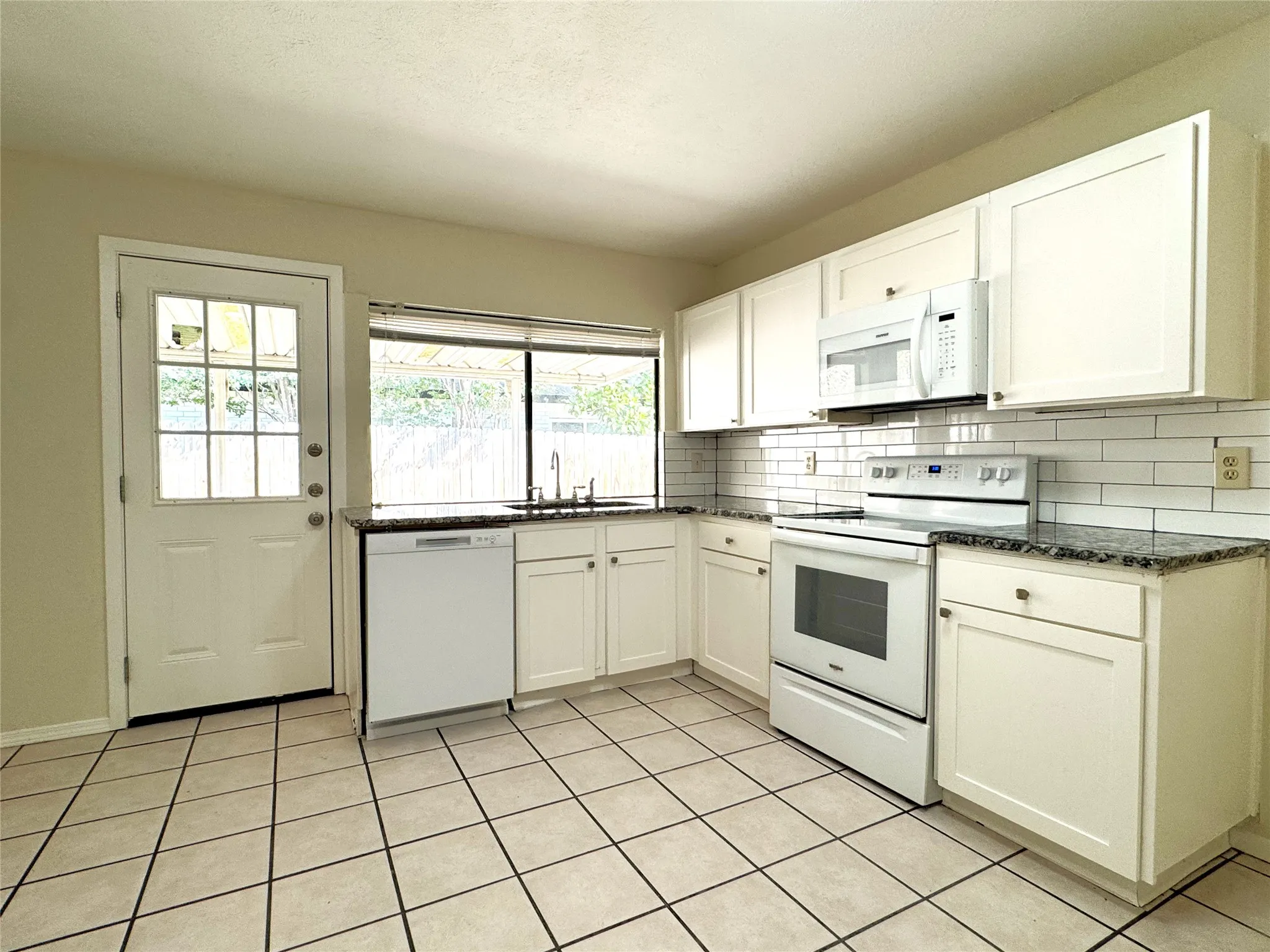 Kitchen opens to a large, covered patio