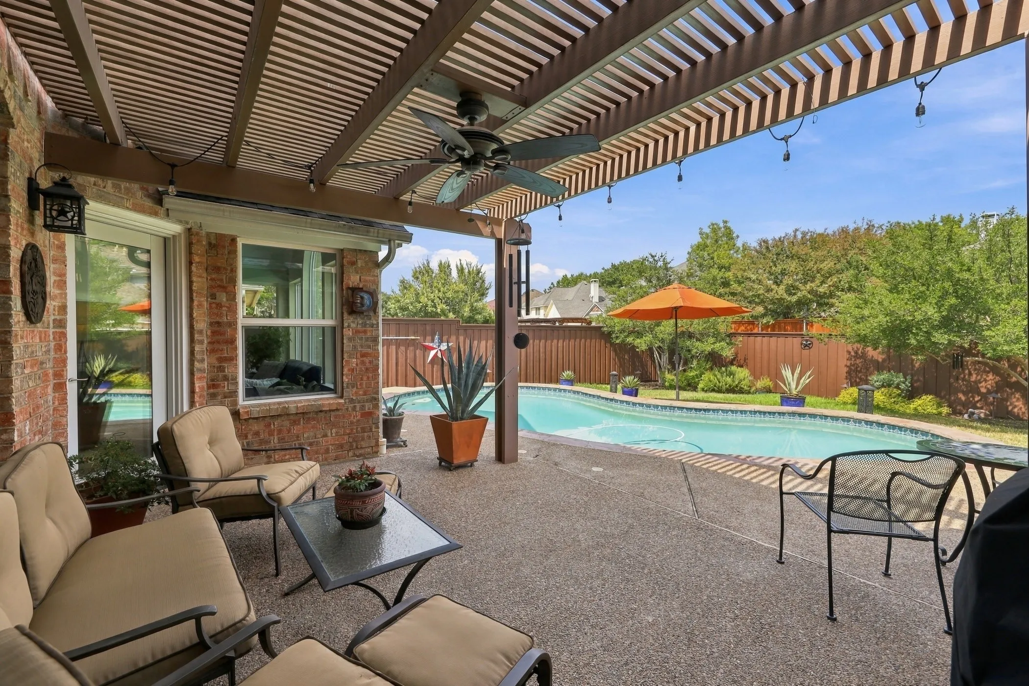Enjoy the shad under the covered patio overlooking pool!  Backyard faces Northeast, providing afternoon shade.