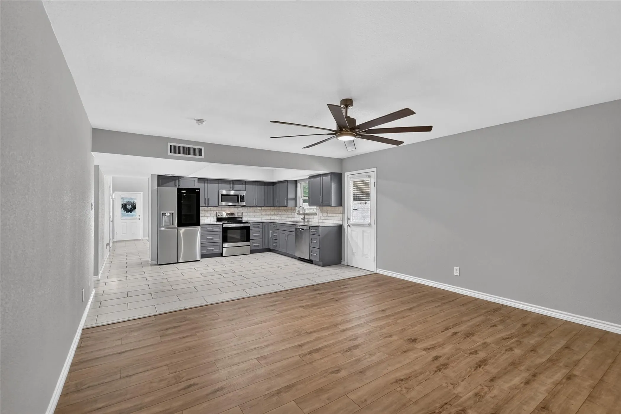 Open-concept living area off of the kitchen can be used as a second living room or flex space to entertain