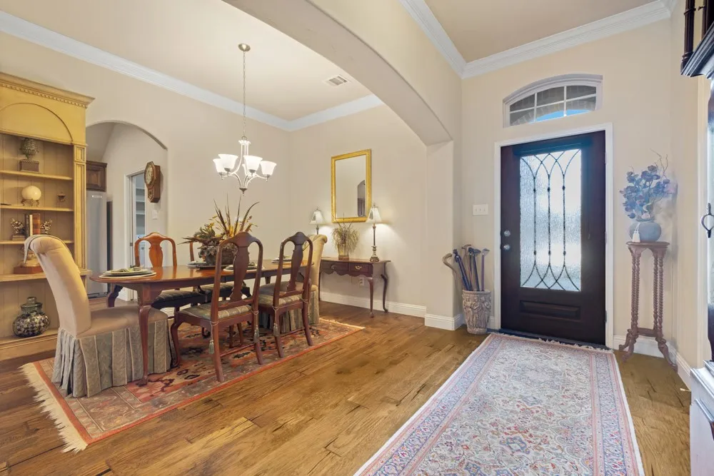 As you walk through the entry, you'll immediately notice the upgrades in this home.  Wood flooring, crown molding, 4 in baseboards, 12 ft ceilings and more!