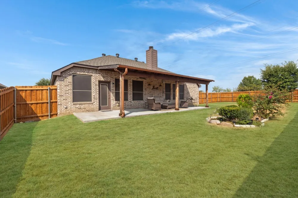 Large back yard with virtually enhanced grass to show Spring- time green.