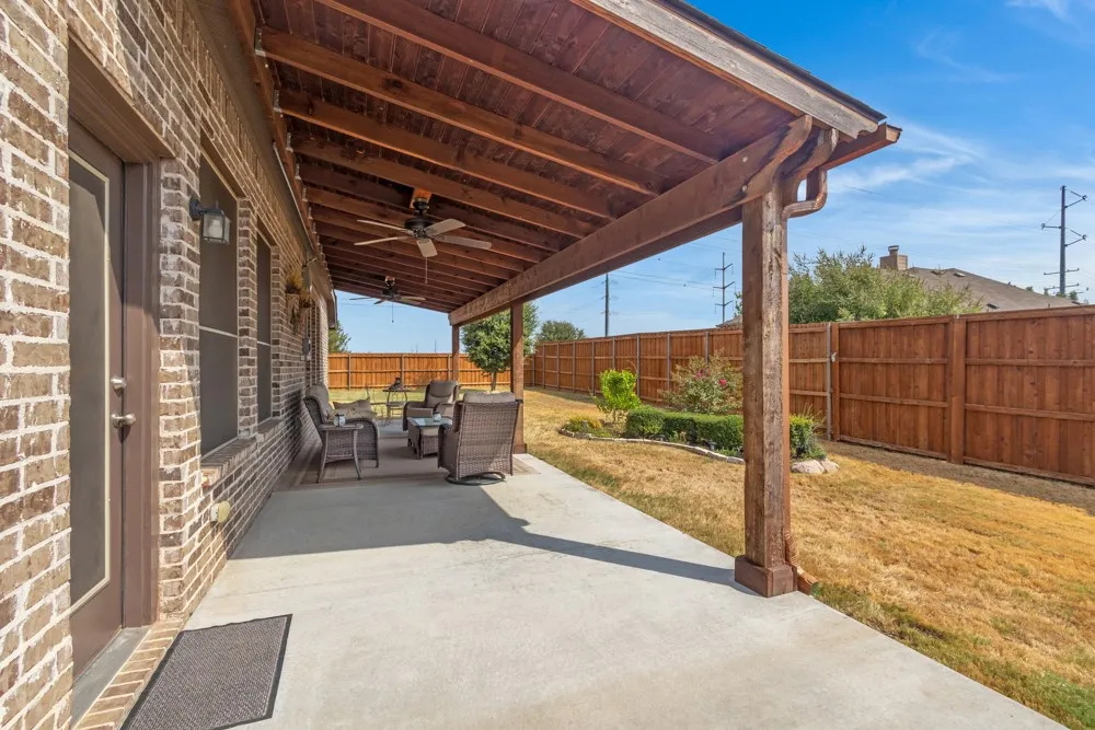 Enjoy spending time on this large, covered patio with ceiling fans as well as wiring for a hot tub already in place!