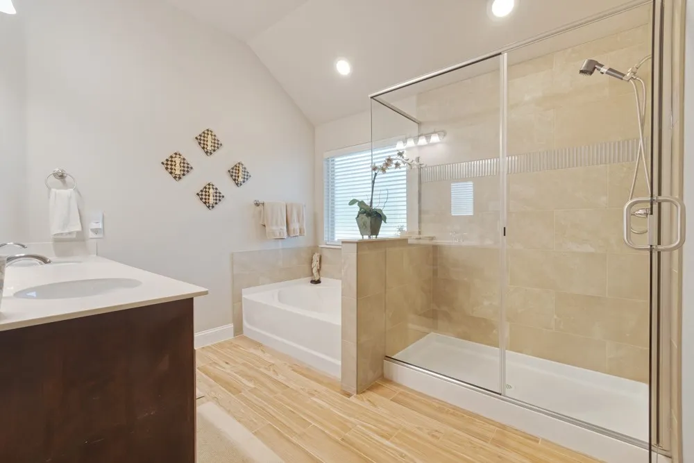 Recently updated primary bathroom with an oversized walk-in shower, separate tub, dual sinks as well as a large walk-in closet you wont want to miss!