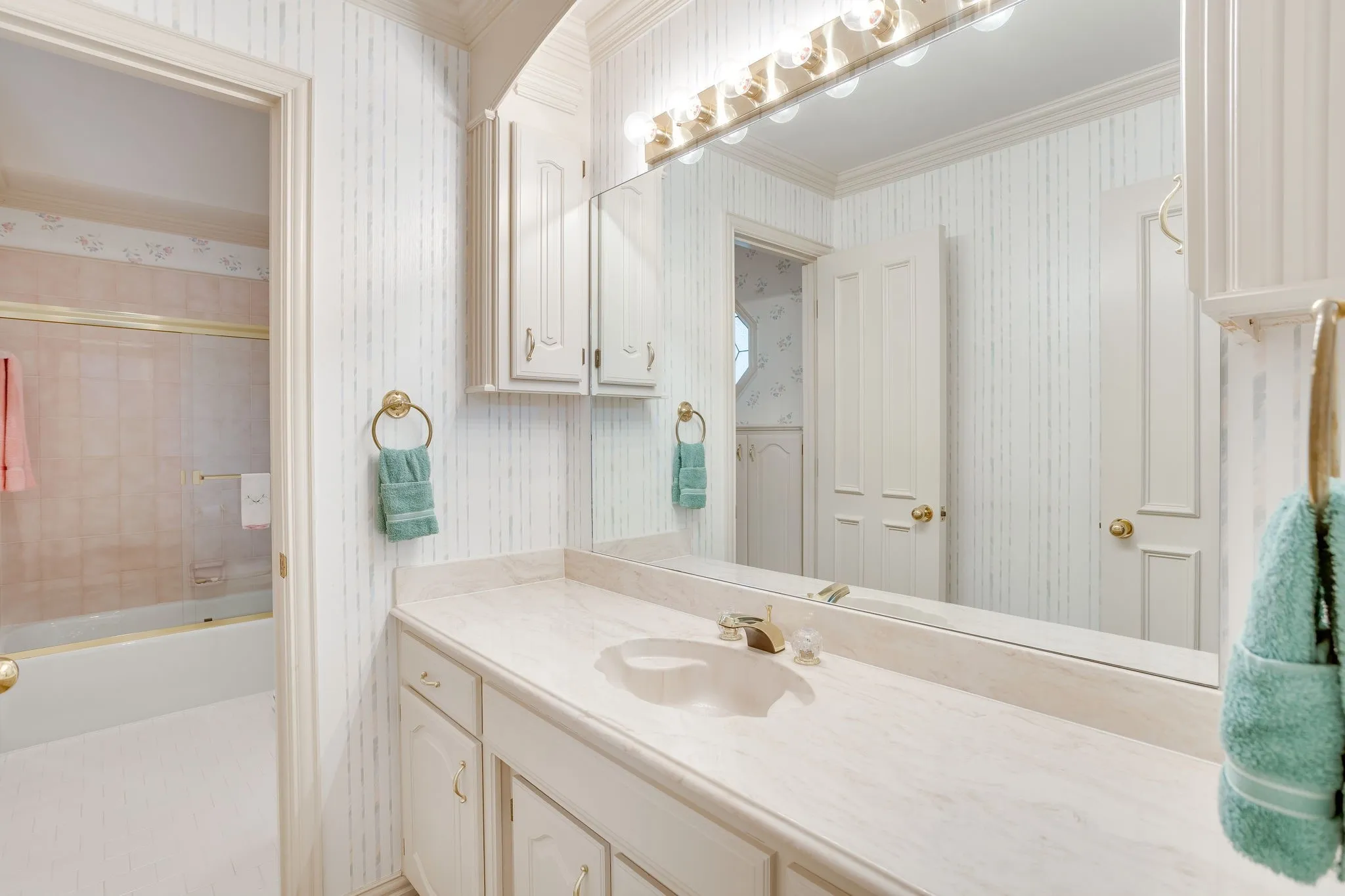 Vanity with integrated sink, extensive countertop, and built-in cabinetry