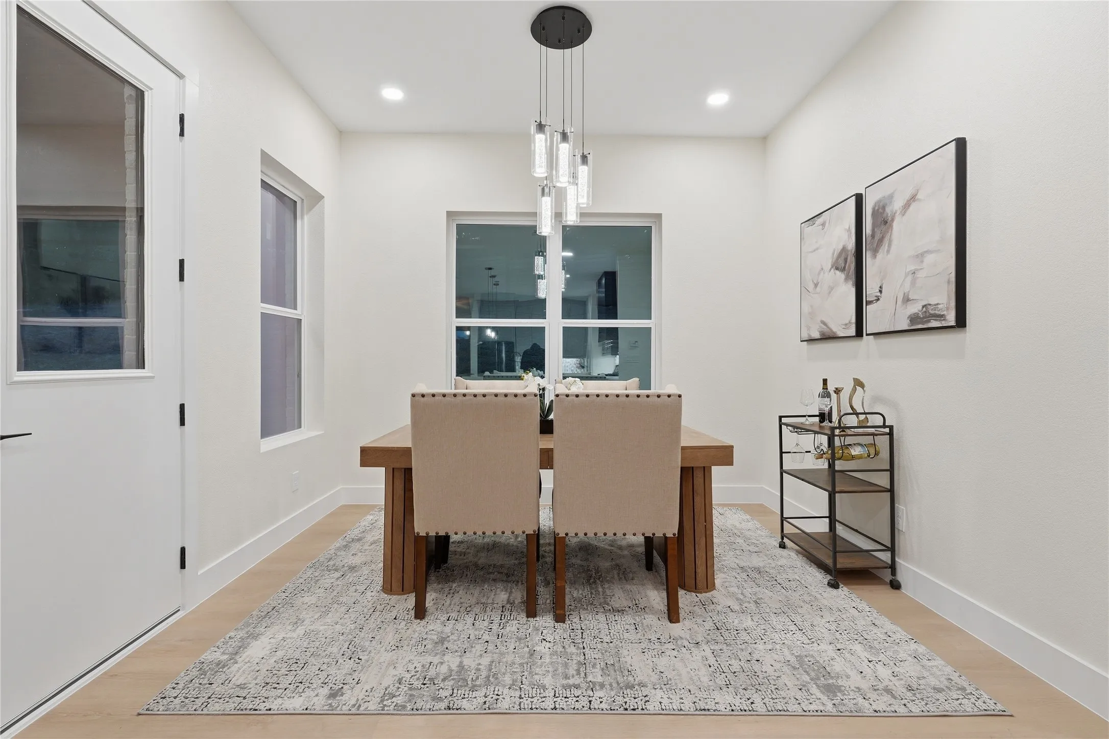Recessed lighting, light wood-finish flooring, and multiple windows