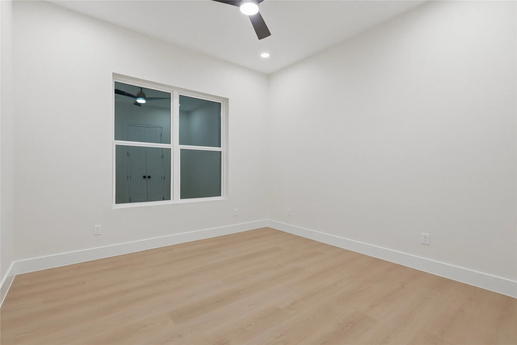 Recessed lighting, ceiling fan, white trim, wood-finish flooring, and white walls