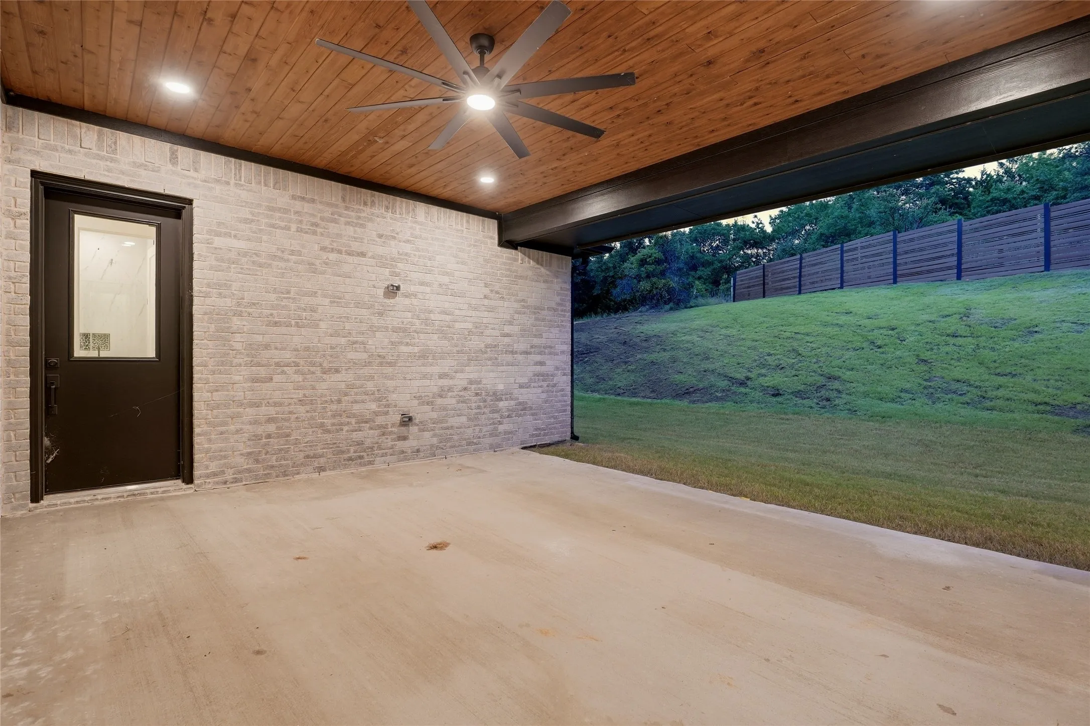 Covered patio featuring a wood-paneled ceiling, recessed lighting, and a ceiling fan