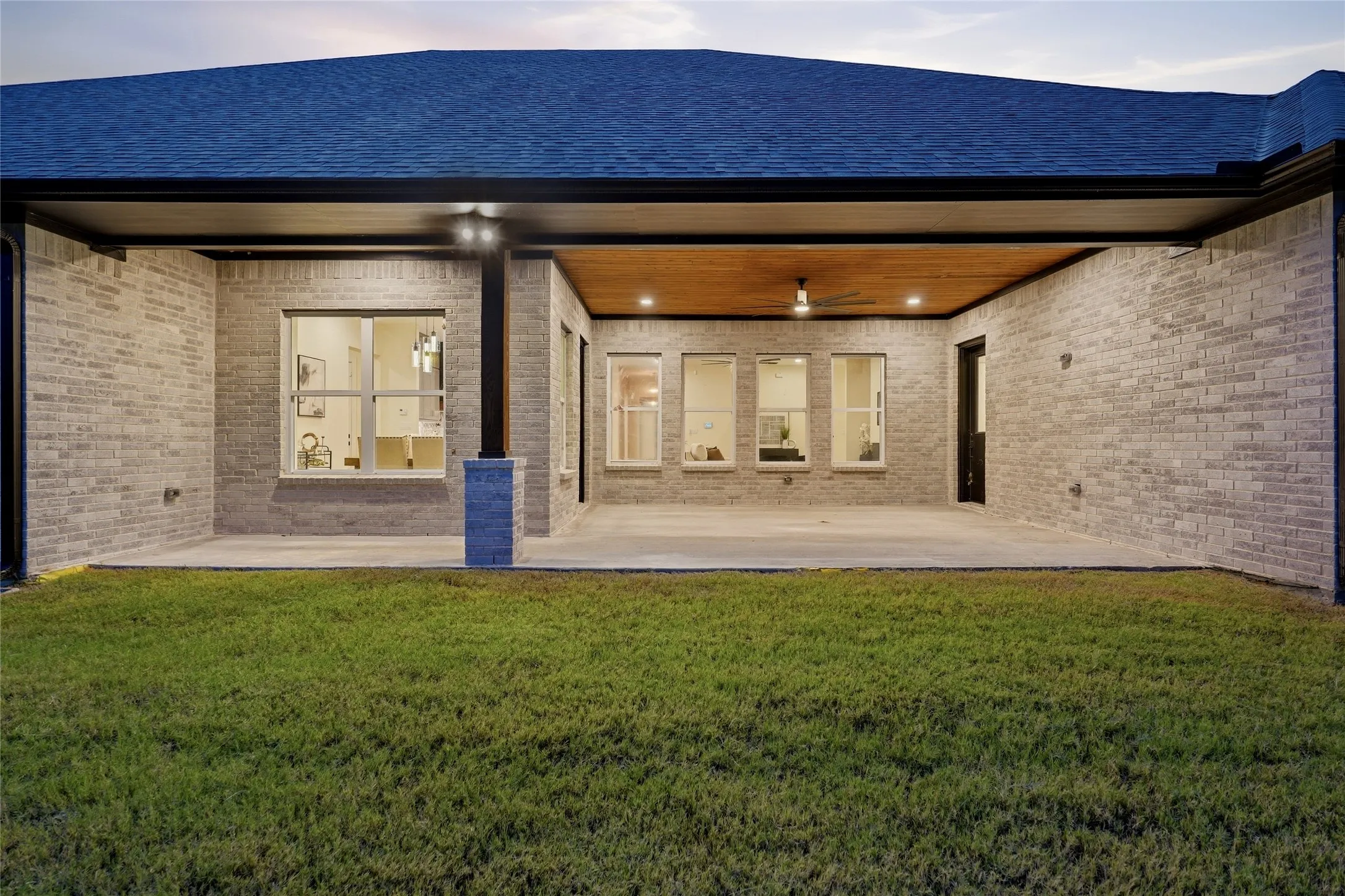 Expansive covered patio featuring a wood-finish ceiling, recessed lighting, and a ceiling fan