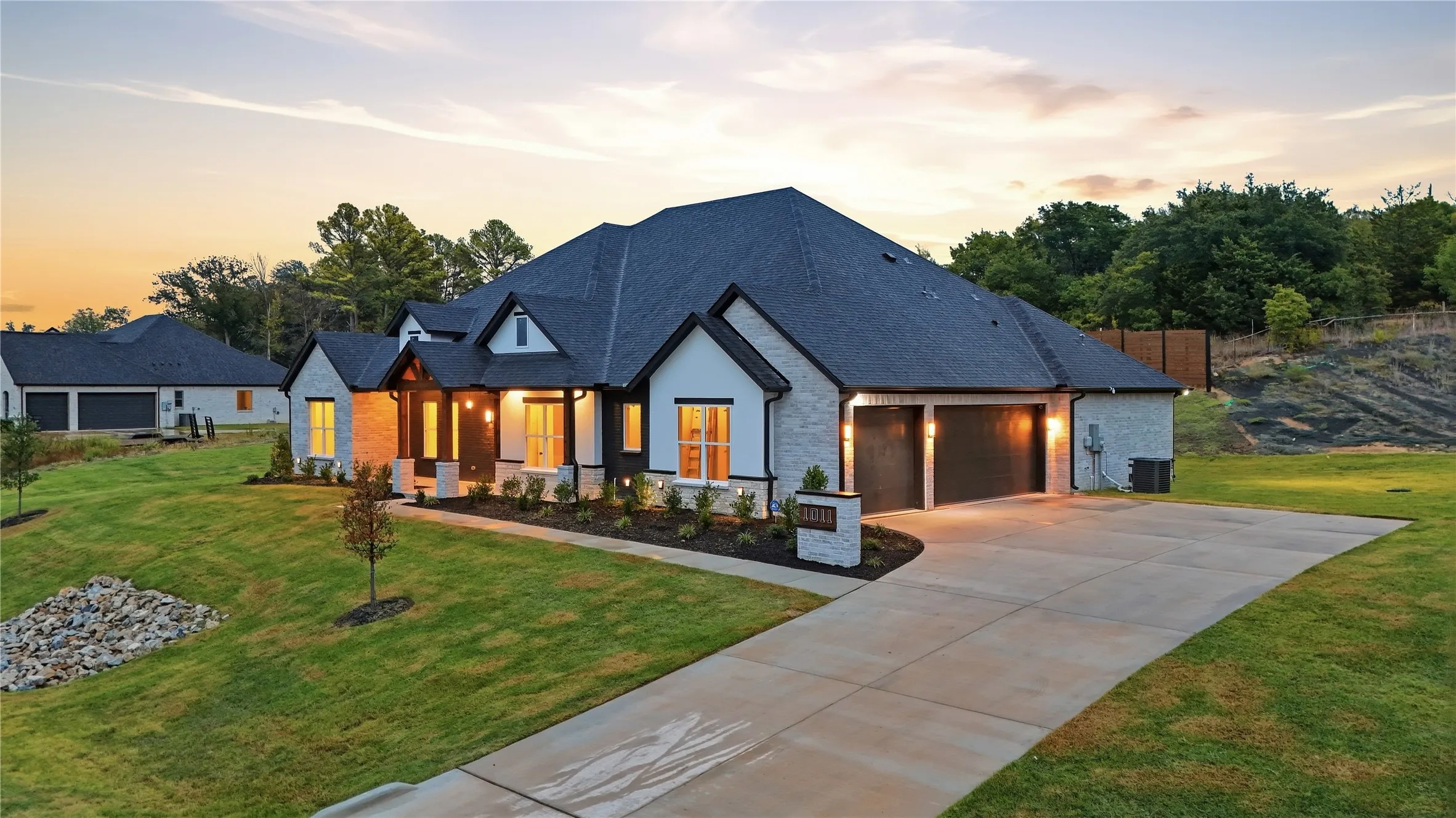 Stone and siding exterior with a dark shingle roof