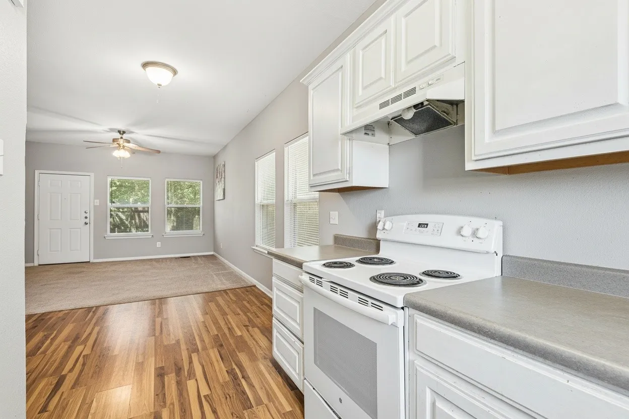 Kitchen opens directly to the dining area, creating a connected layout with natural light and easy-care wood-look flooring. | 5933 Robinwood