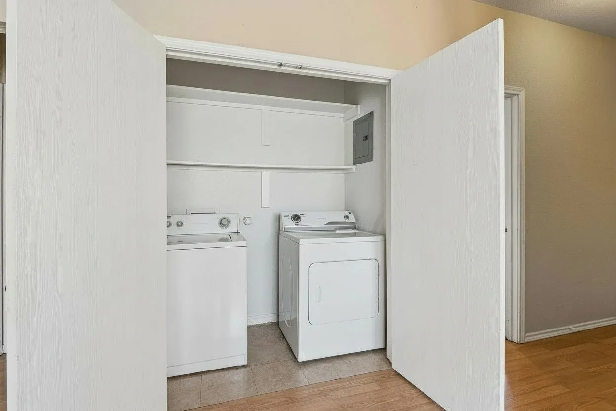 Separate full-size utility room keeps laundry tucked away behind a closing door and includes convenient storage shelving above. | 5931 Robinwood