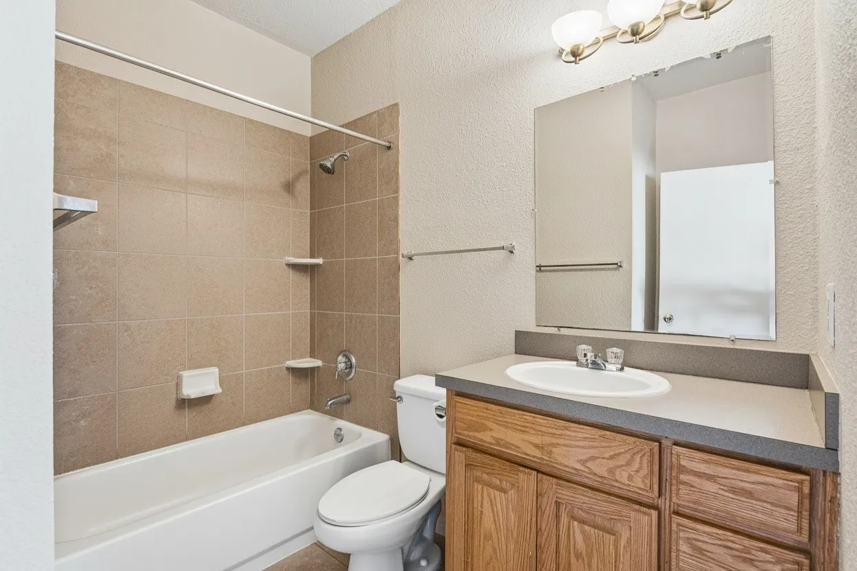 Full bathroom features ceramic tile flooring and a tiled tub and shower surround for a durable, easy-care finish. | 5931 Robinwood