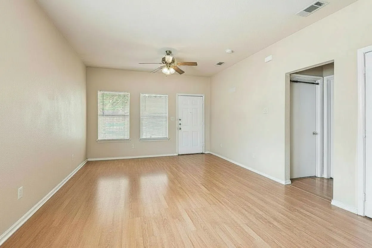 Multiple windows bring natural light into the spacious living area, while neutral finishes provide an adaptable backdrop for furnishings. | 5931 Robinwood