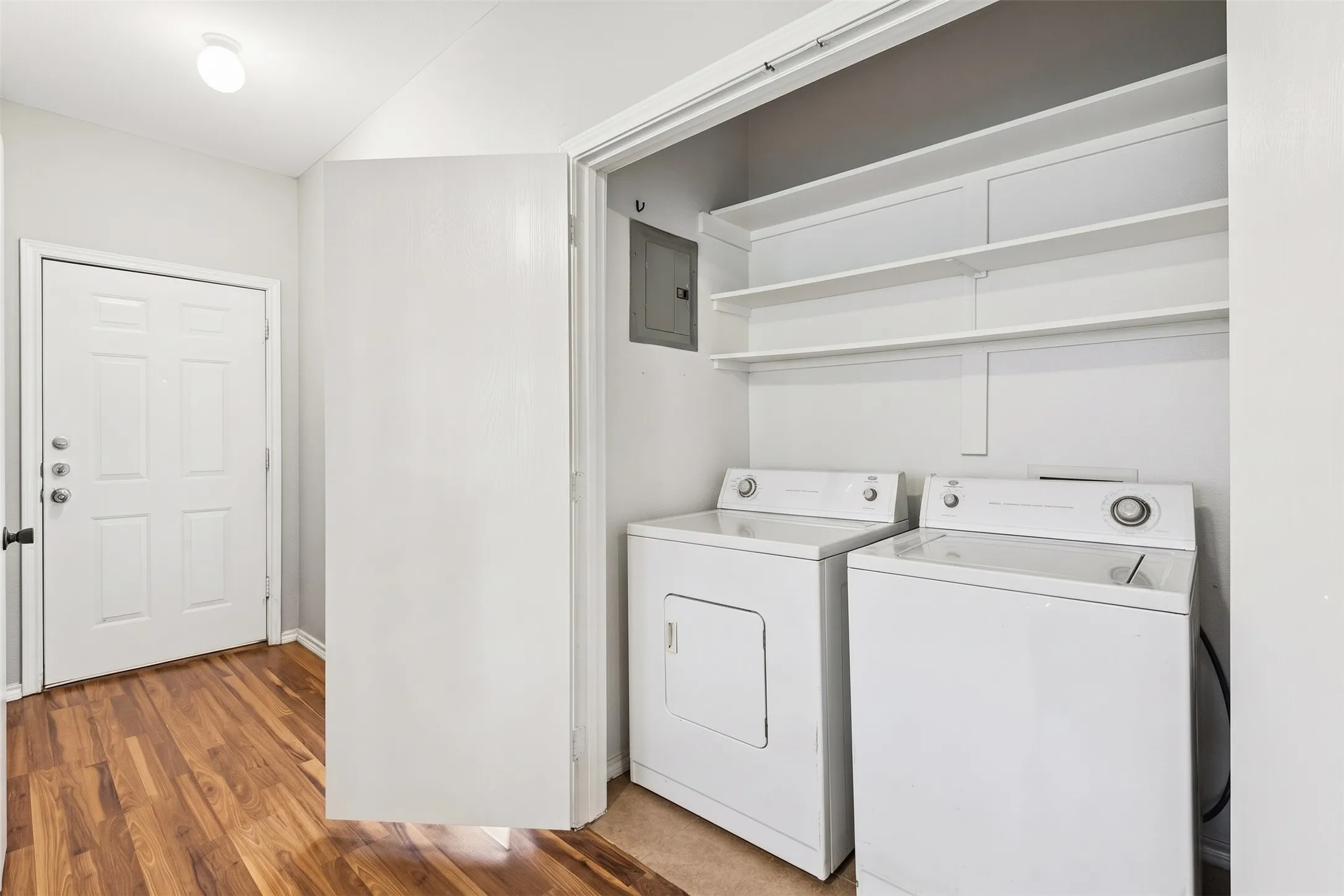 Dedicated full-size utility room keeps laundry separate from the living areas and provides useful overhead storage shelving. | 5933 Robinwood