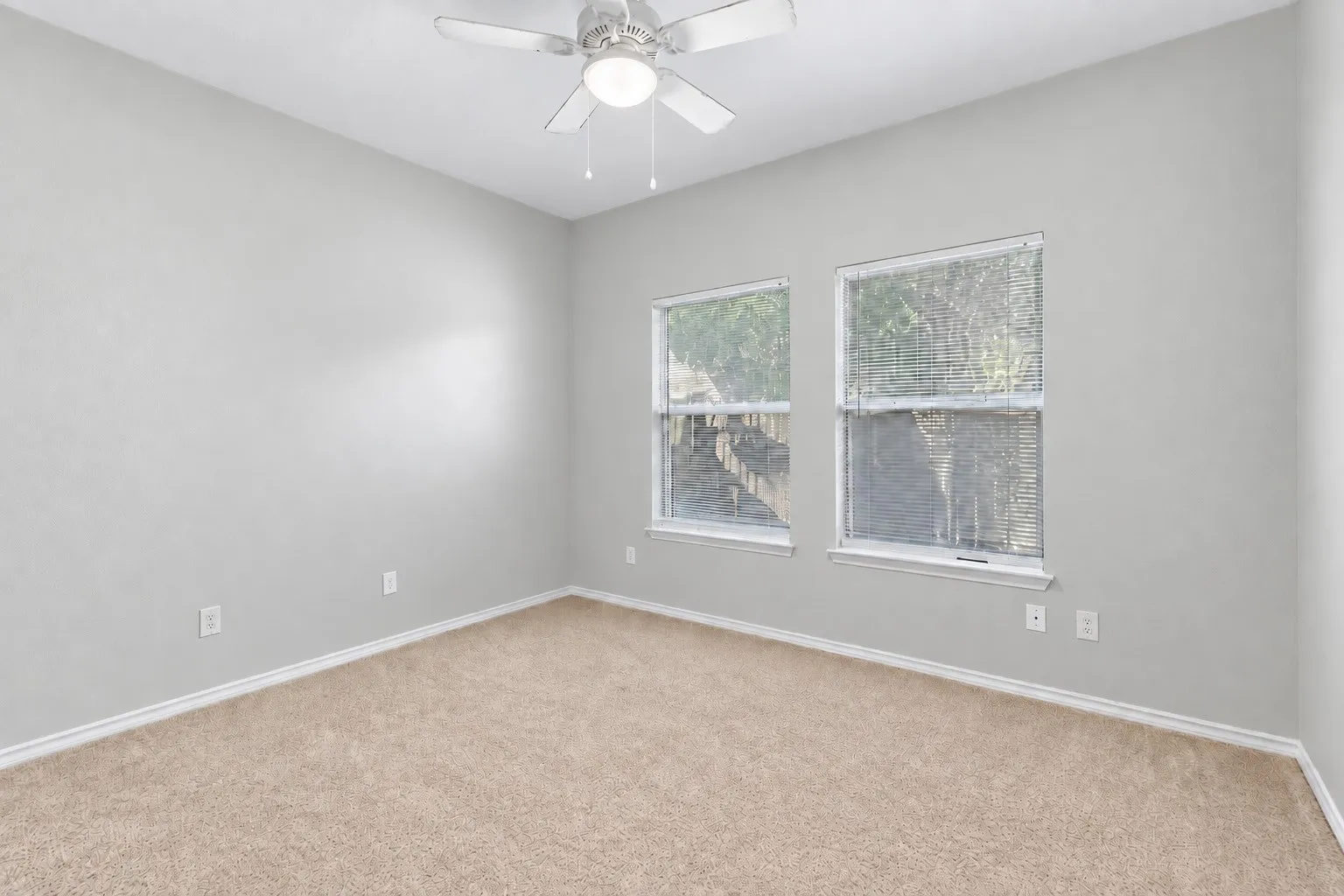 Additional bedroom view showcases the room's usable proportions, multiple windows and versatile neutral palette. | 5933 Robinwood