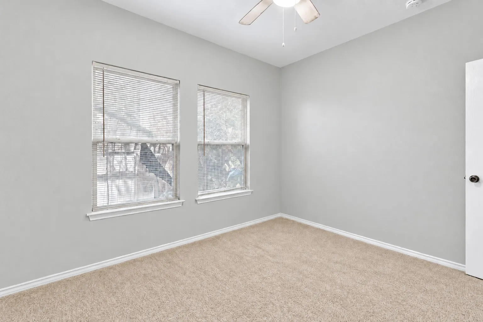 Second carpeted bedroom offers neutral finishes, natural light and flexible space for a variety of furniture arrangements. | 5933 Robinwood