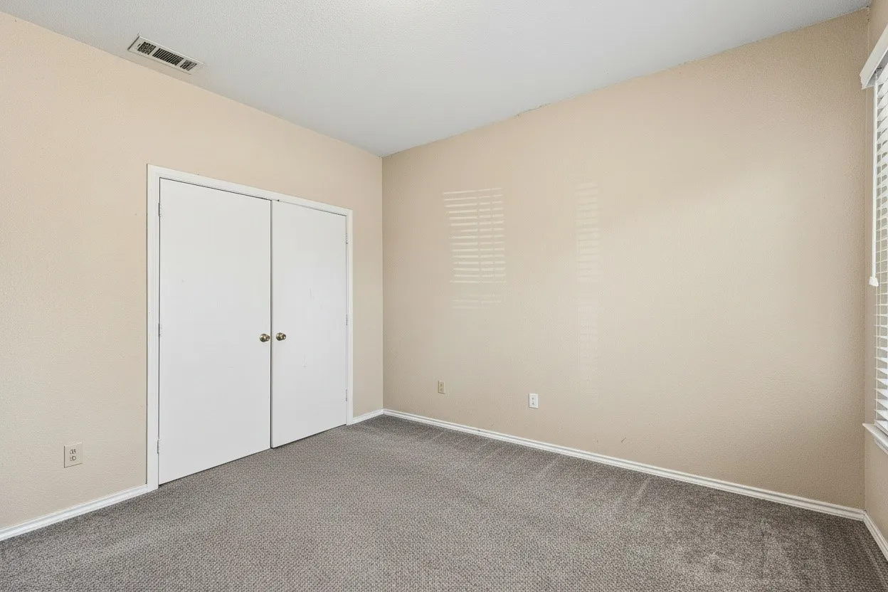 Second carpeted bedroom features neutral finishes and closet storage, completing the functional 2-bedroom floor plan. | 5931 Robinwood