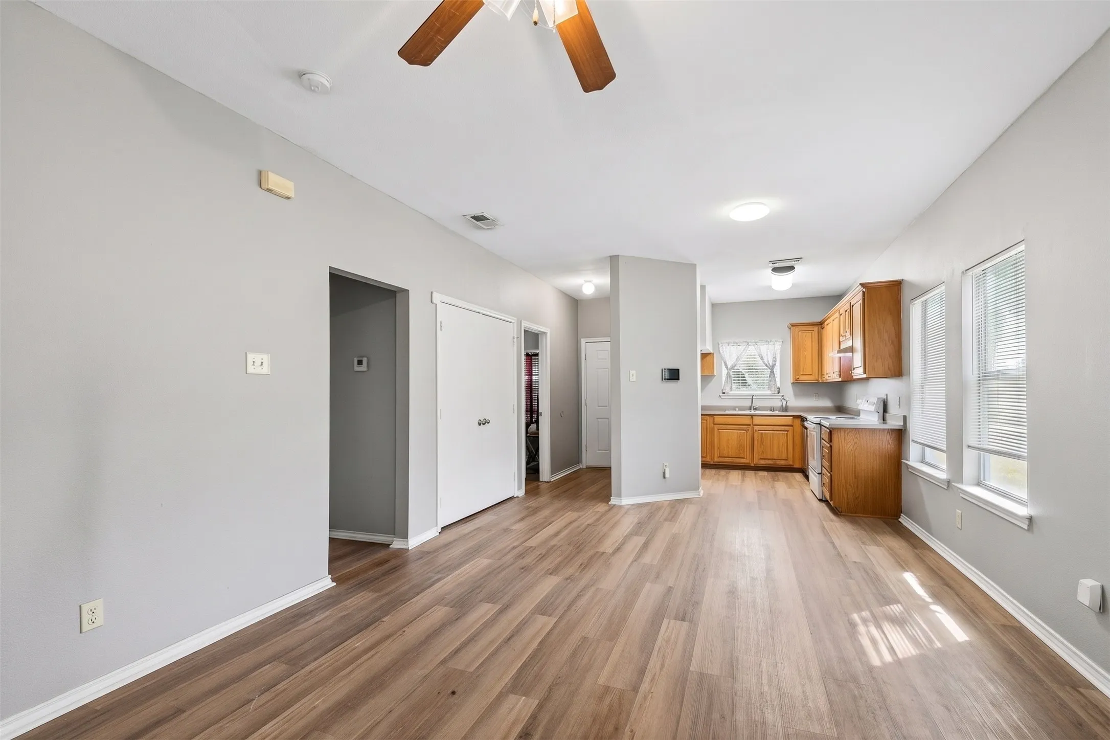 Multiple windows bring natural light into the spacious living area, while neutral finishes provide an adaptable backdrop for furnishings. | 5959 Robinwood