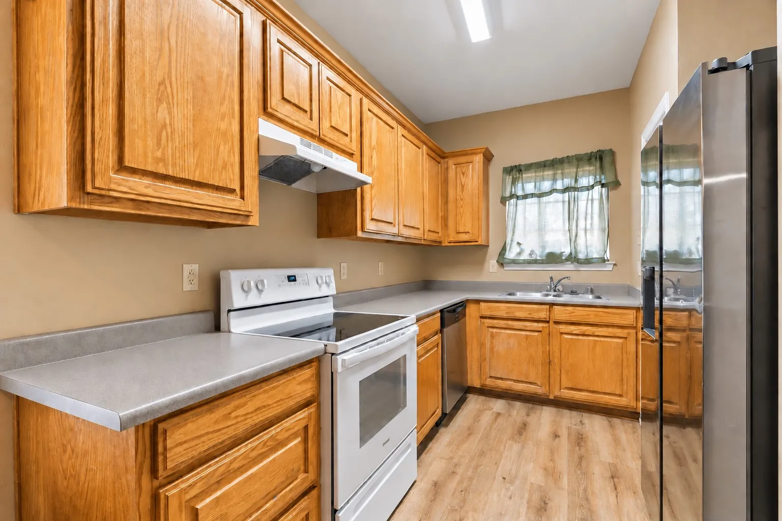 Kitchen offers durable laminate counters, stained cabinetry and slide-in electric range. | 5961 Robinwood