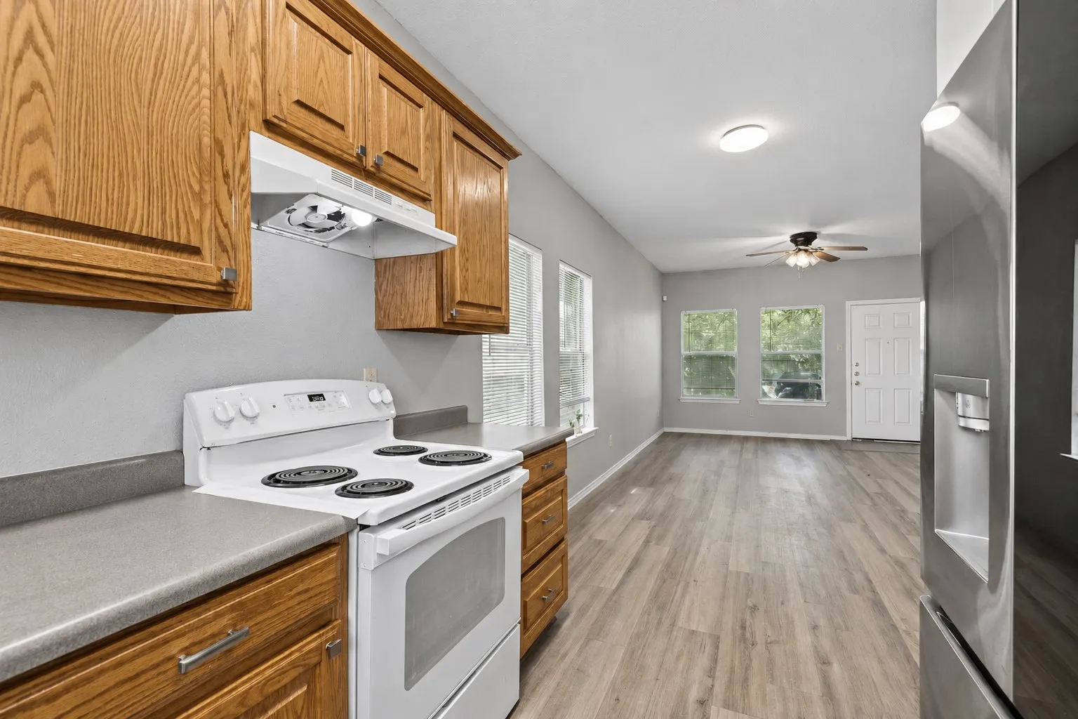 Wood-look laminate flooring creates a cohesive flow from the entry into the kitchen and dining areas for practical, low-maintenance everyday living. | 5959 Robinwood