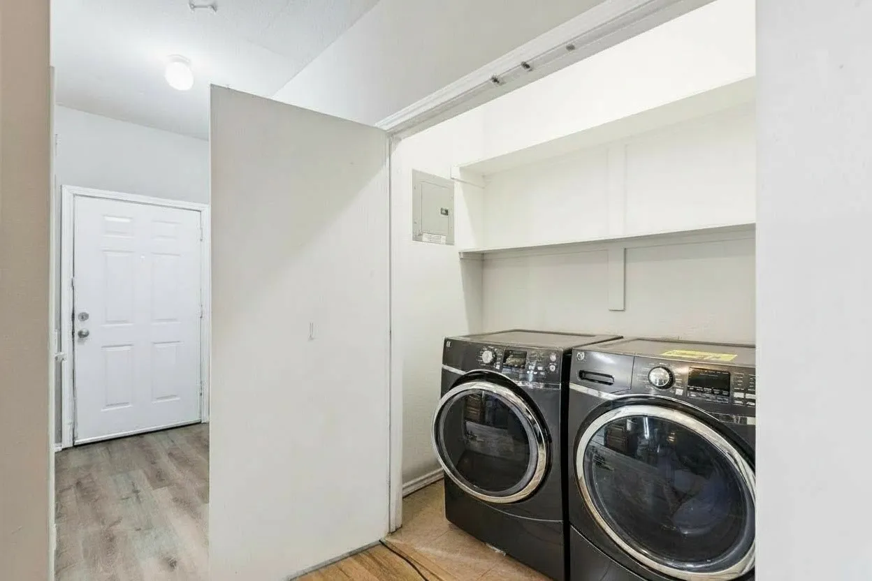 Separate, full size laundry room with convenient shelving above and ceramic tile flooring. | 5961 Robinwood