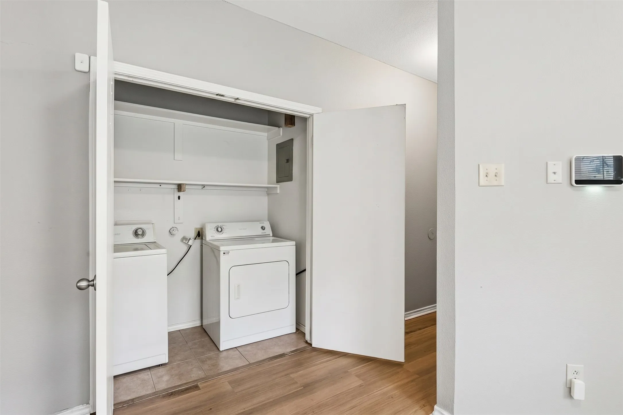 Separate full-size utility room keeps laundry tucked away behind a closing door and includes convenient storage shelving above. | 5959 Robinwood