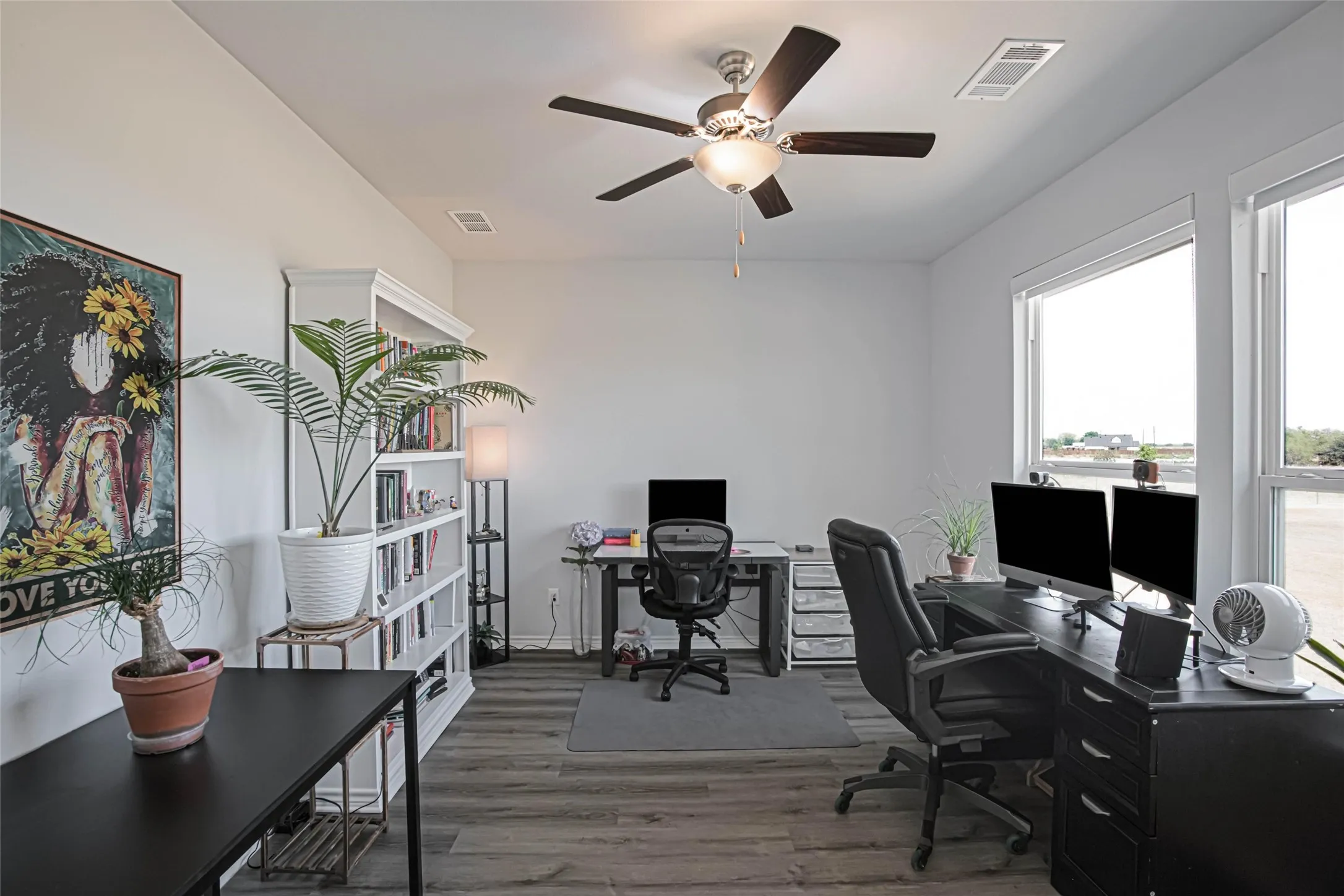 Recessed lighting, wood-finish flooring, and a ceiling fan with integrated lighting