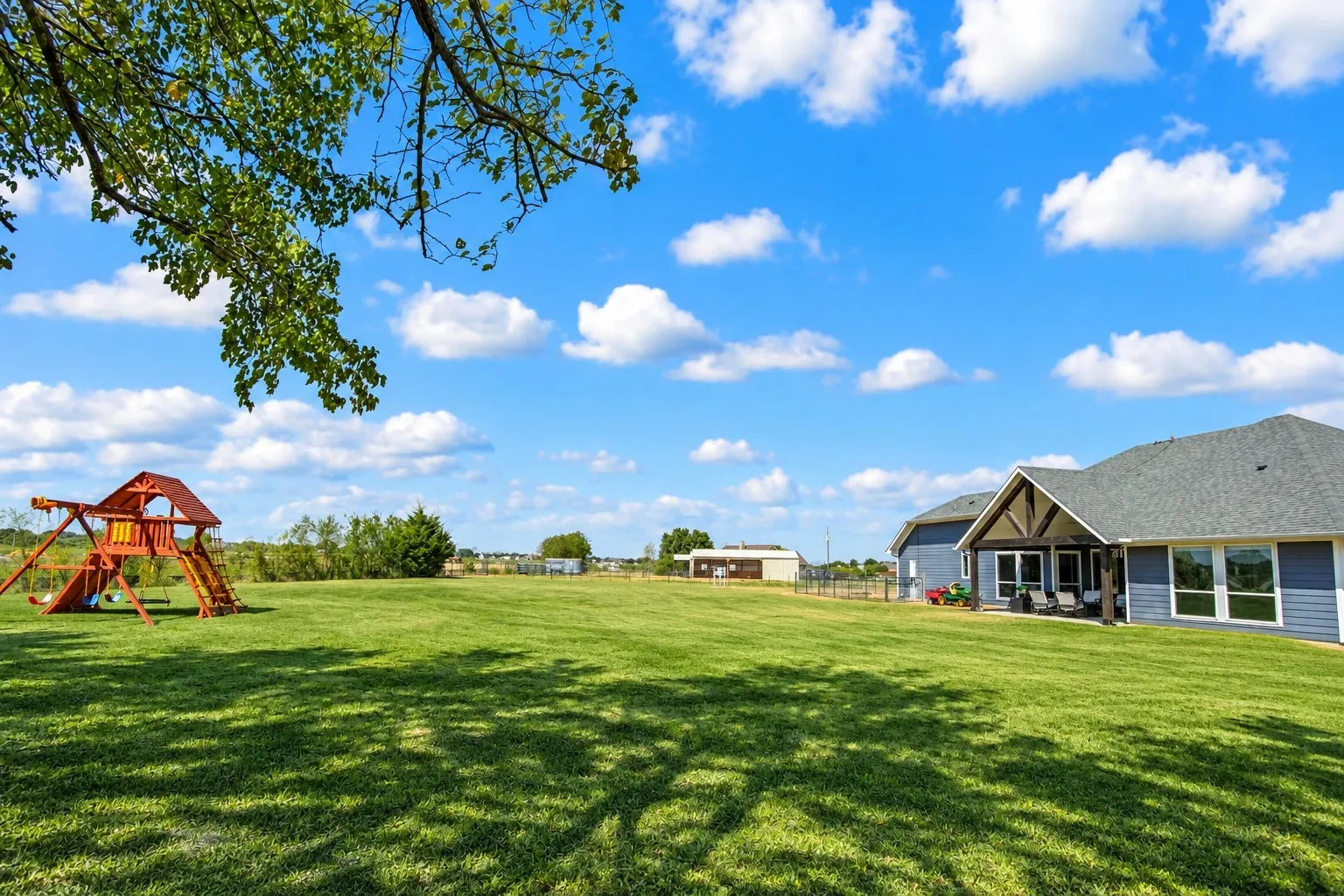 Expansive green lawn with a detached auxiliary building