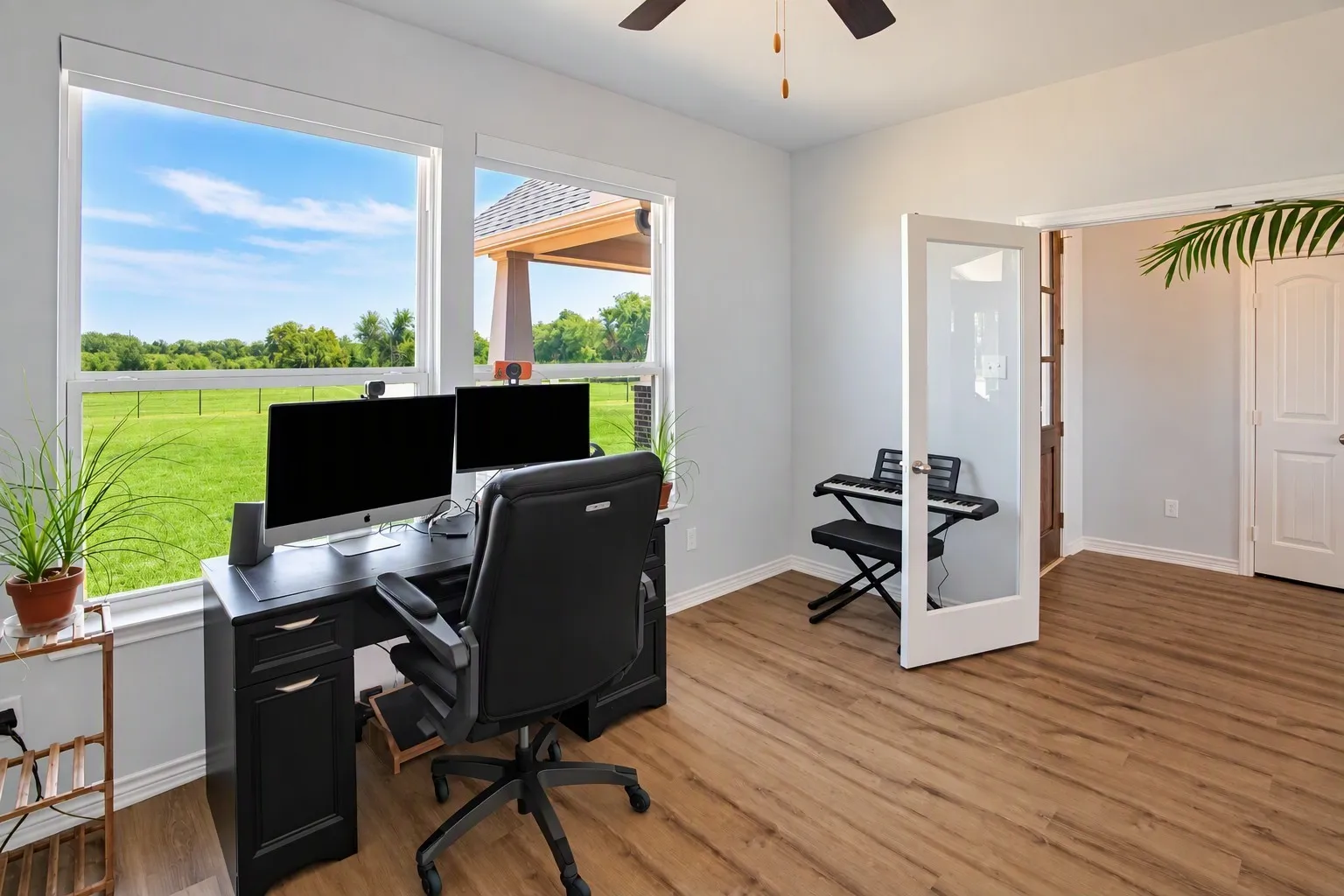 Wood-finish flooring, white trim, and light gray wall paint