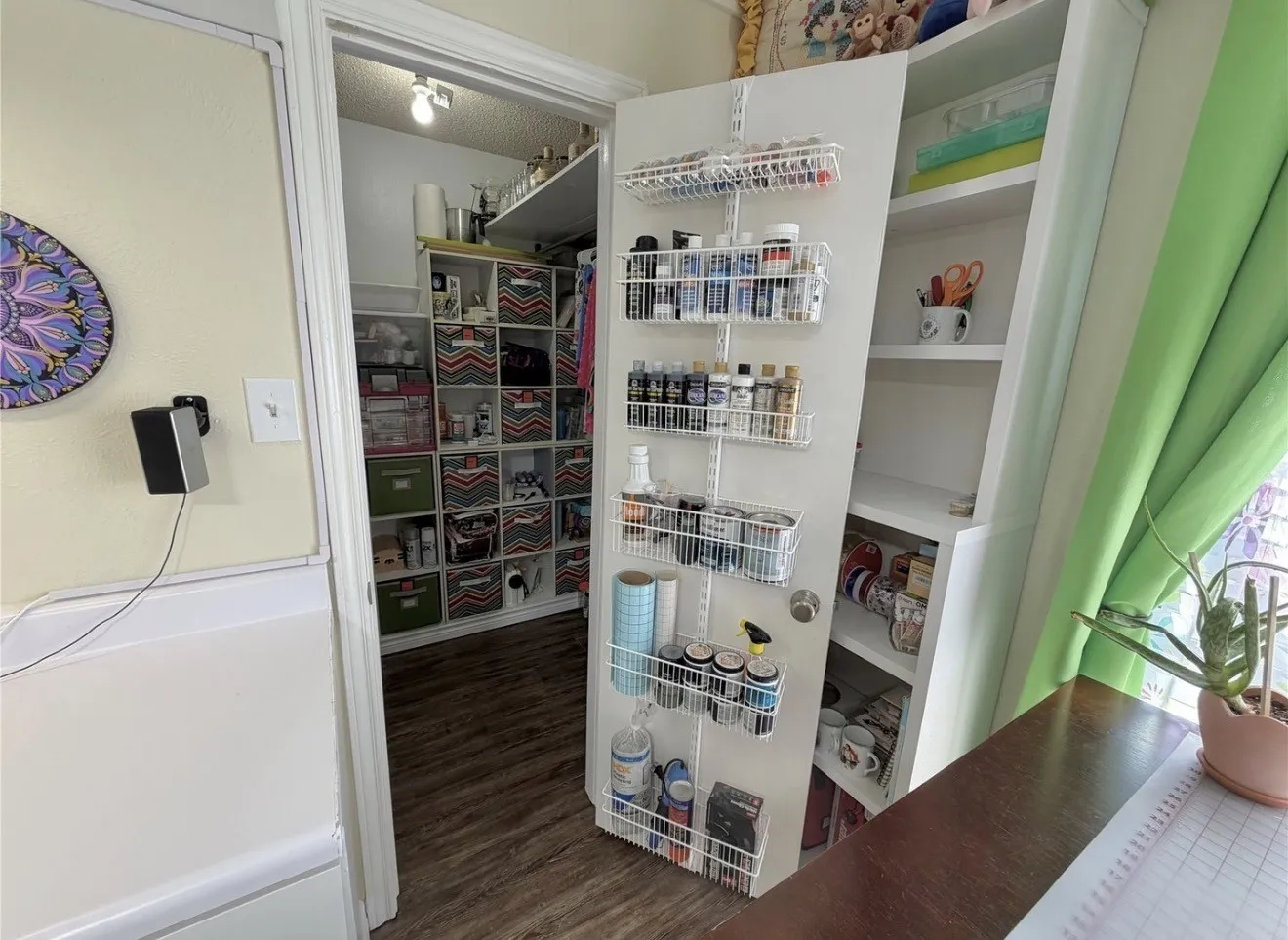 Built-in shelving, white trim, and wood-finish flooring
