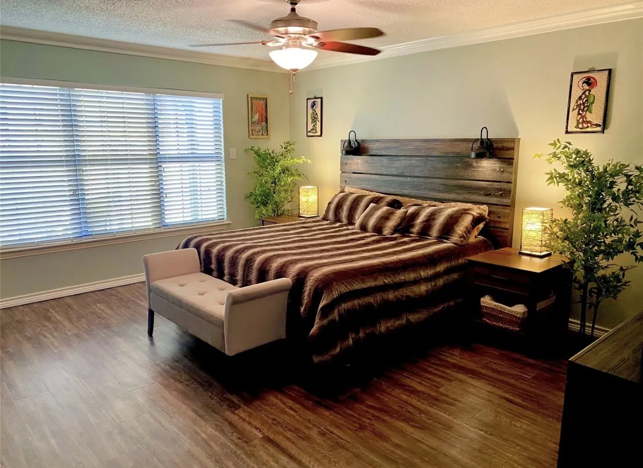 Wood-finish flooring, crown molding, and a ceiling fan with integrated lighting