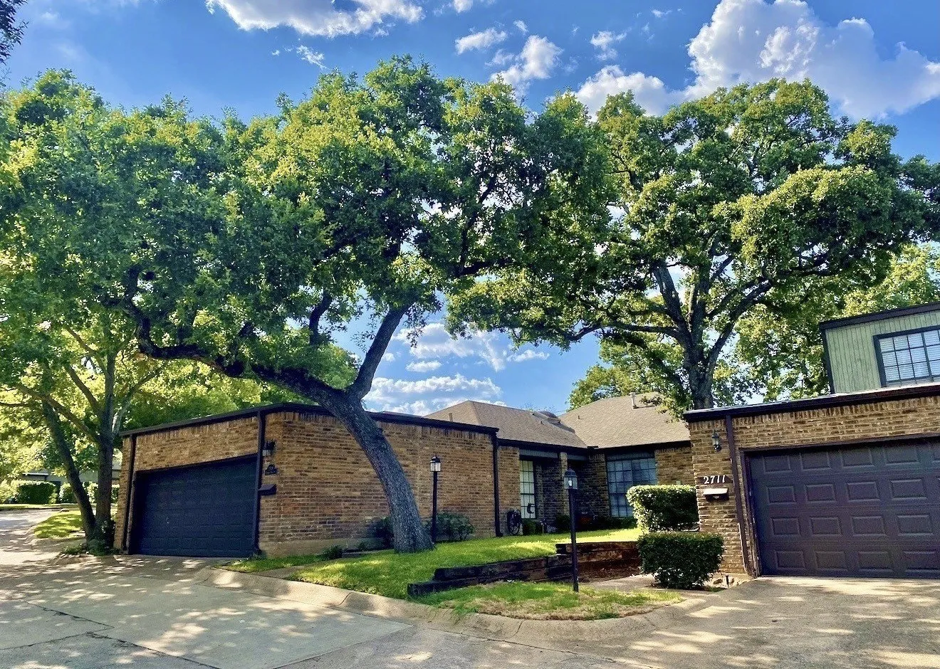 Brick exterior facade, mature trees, attached 2 car garage