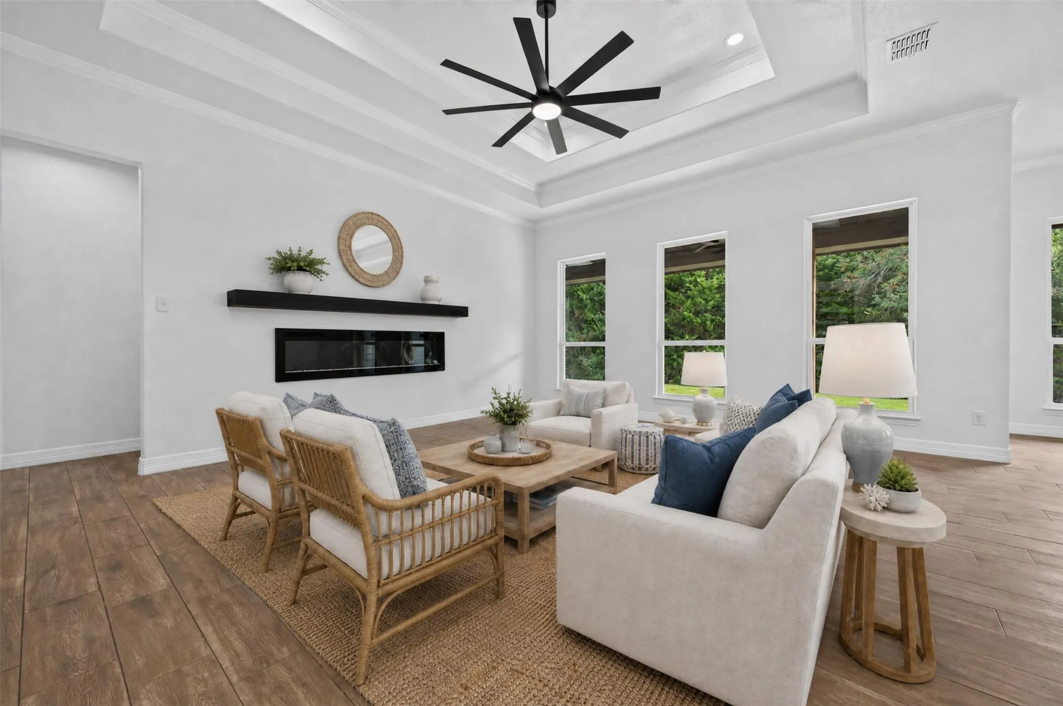 Virtually staged to showcase the spacious living area, modern fireplace, and flexible furniture layout.  *Furniture and decor are digitally rendered*