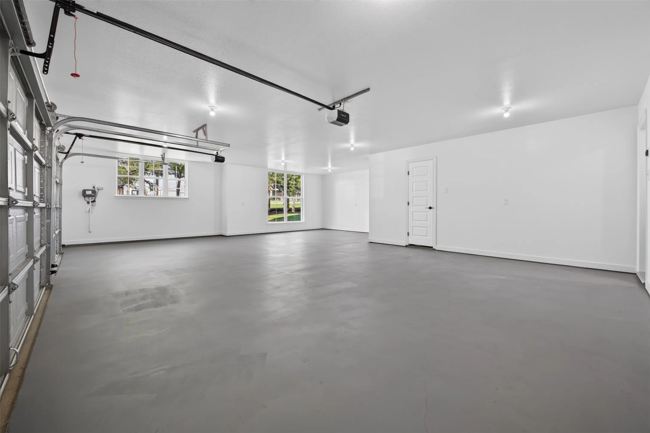 Oversized garage offers abundant parking and storage space with a clean, finished interior.  Features a double and a single overhead door with Chamberlin MyQ openers.  Seperate storage closet, hybrid waterheater area in its own enclosure.