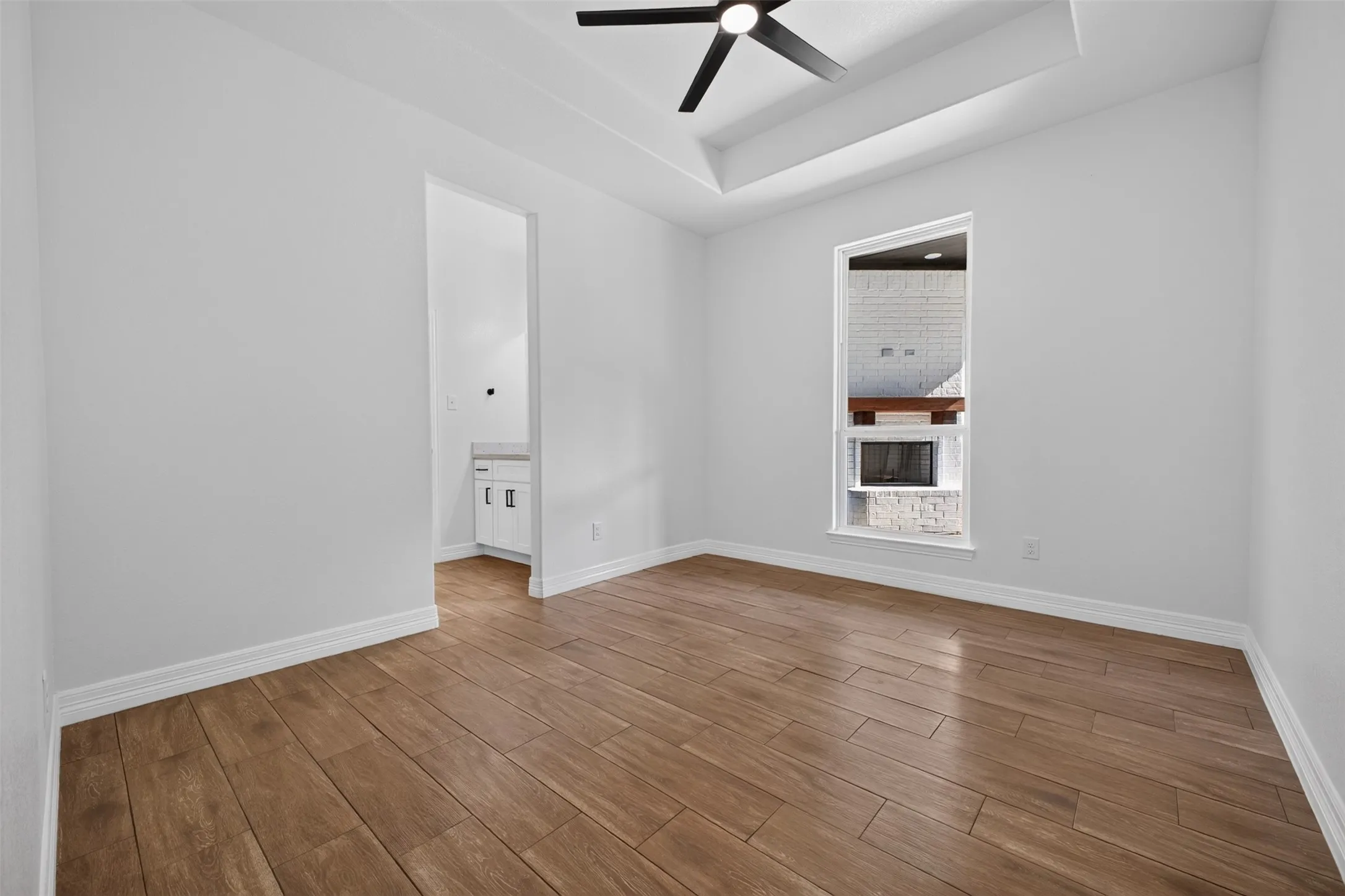 Rear facing bedroom featuring trayed ceiling and direct access to the Janck and Jill en-suite.